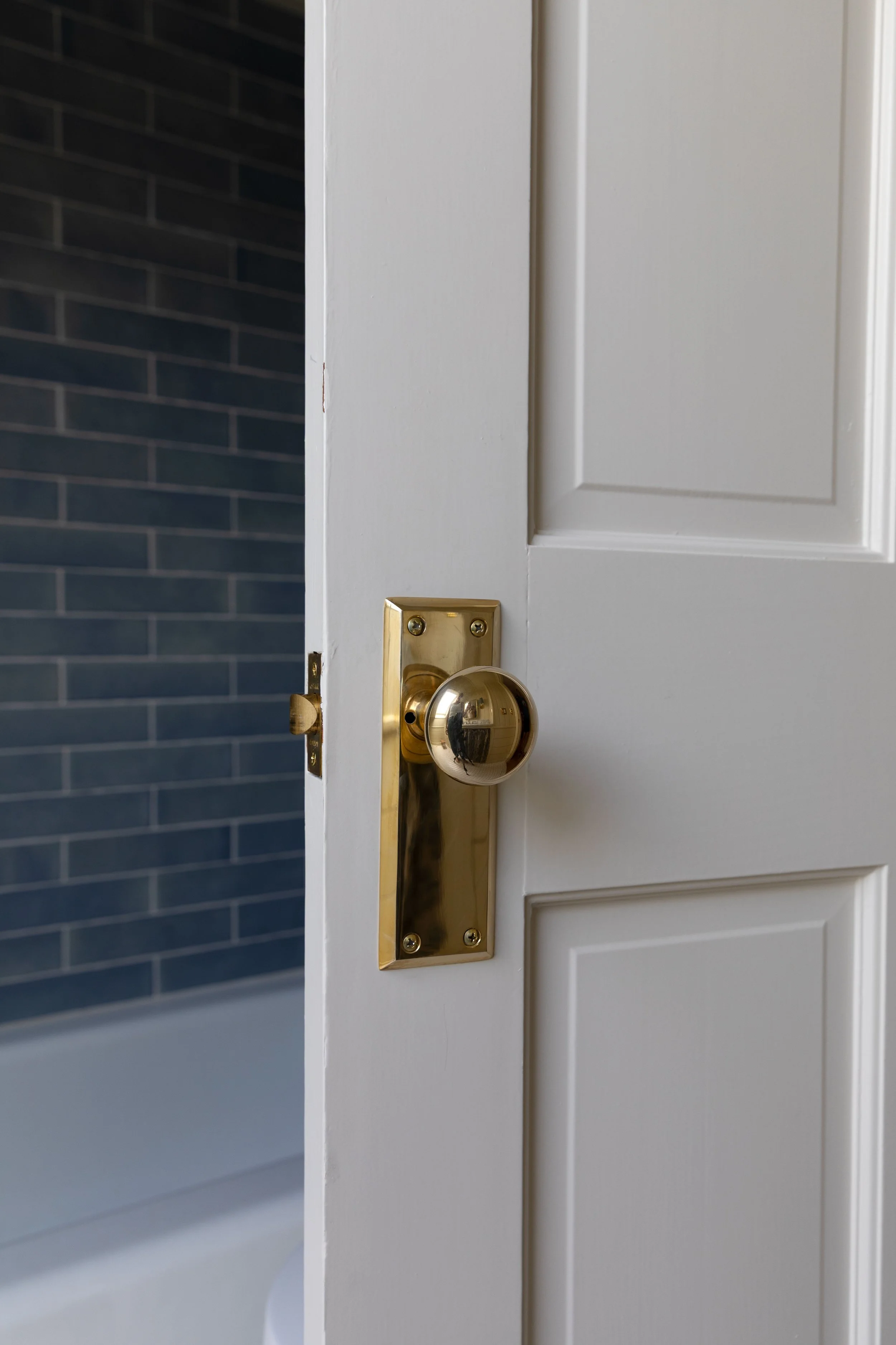 Unlacquered brass doorknob after polishing, with the original bright brass finish restored