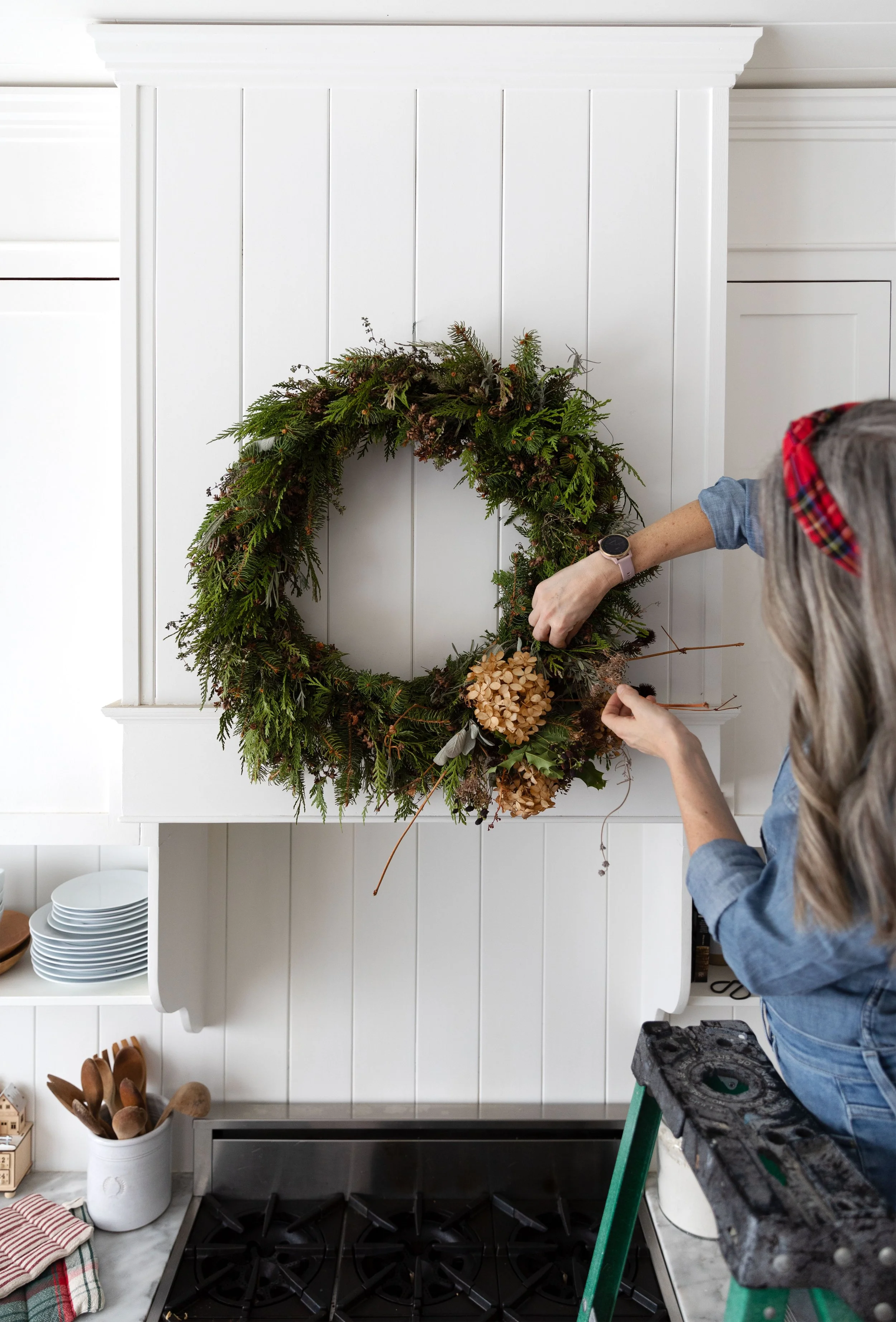 Neutral farmhouse kitchen decorated for Christmas with handmade wreath.