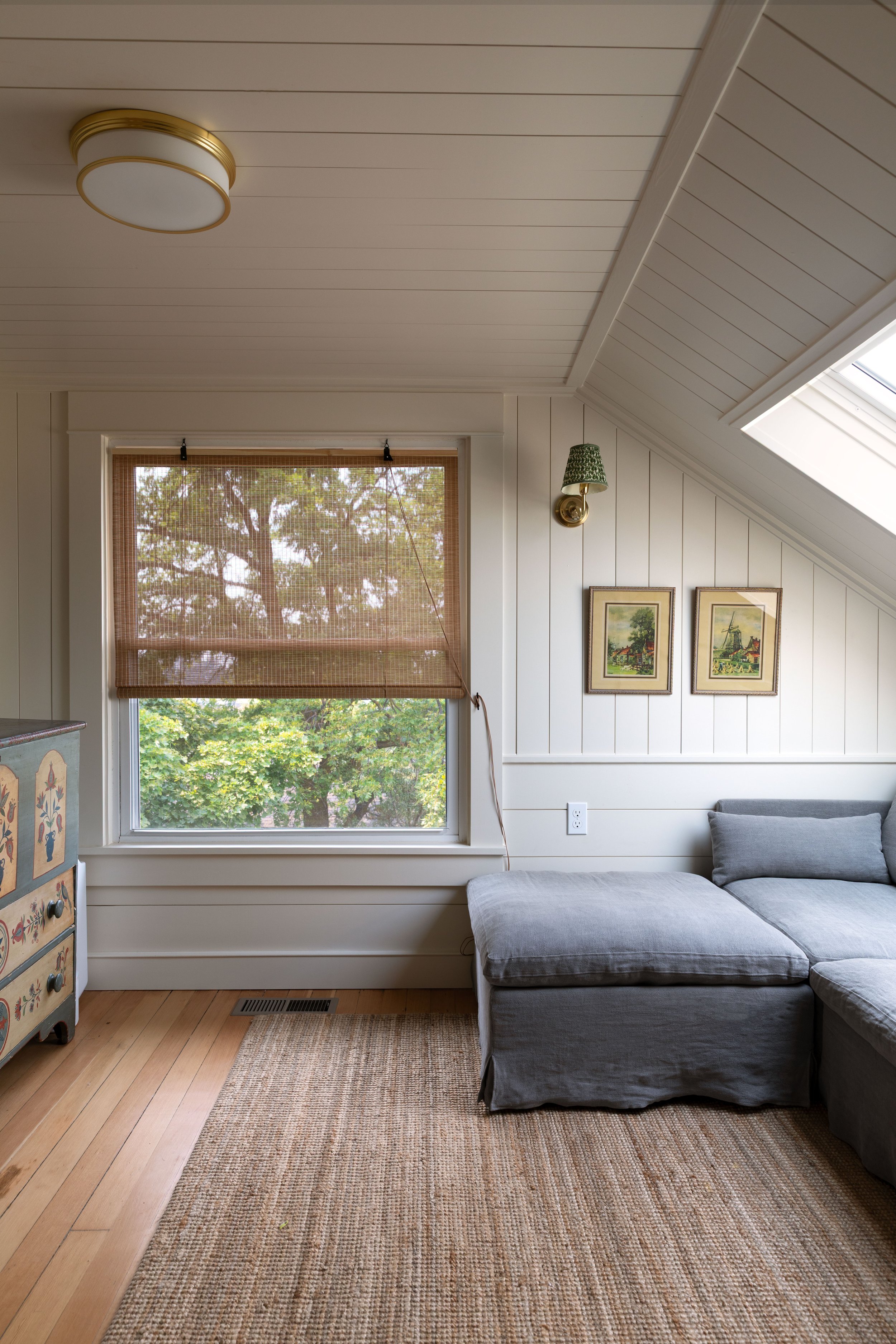 The Hill House snug with white walls and bamboo roller shade