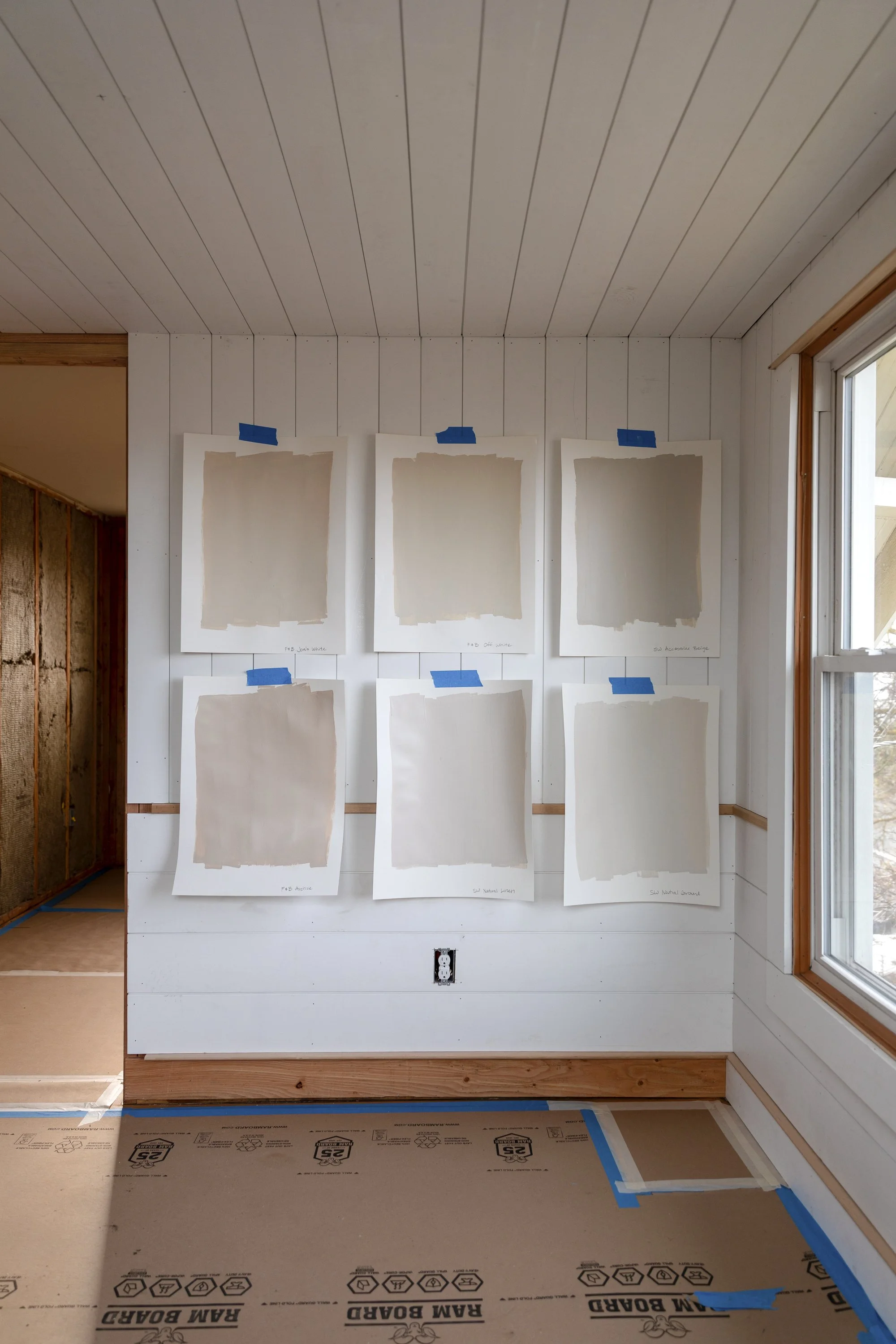 Six favorite warm neutral paint colors tested on planked walls for a cozy old house hallway