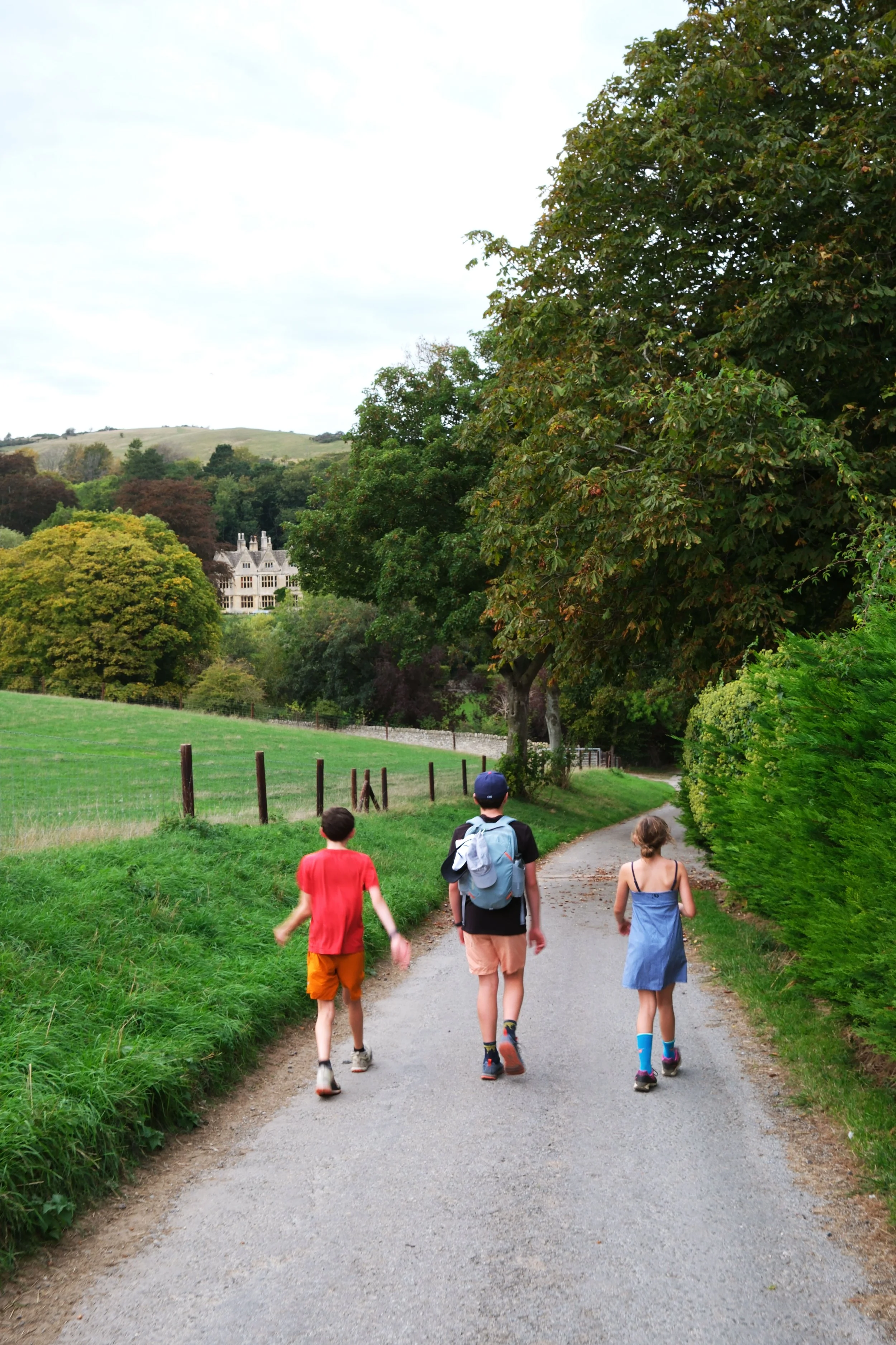 Family hiking the Cotswold Way through the English countryside