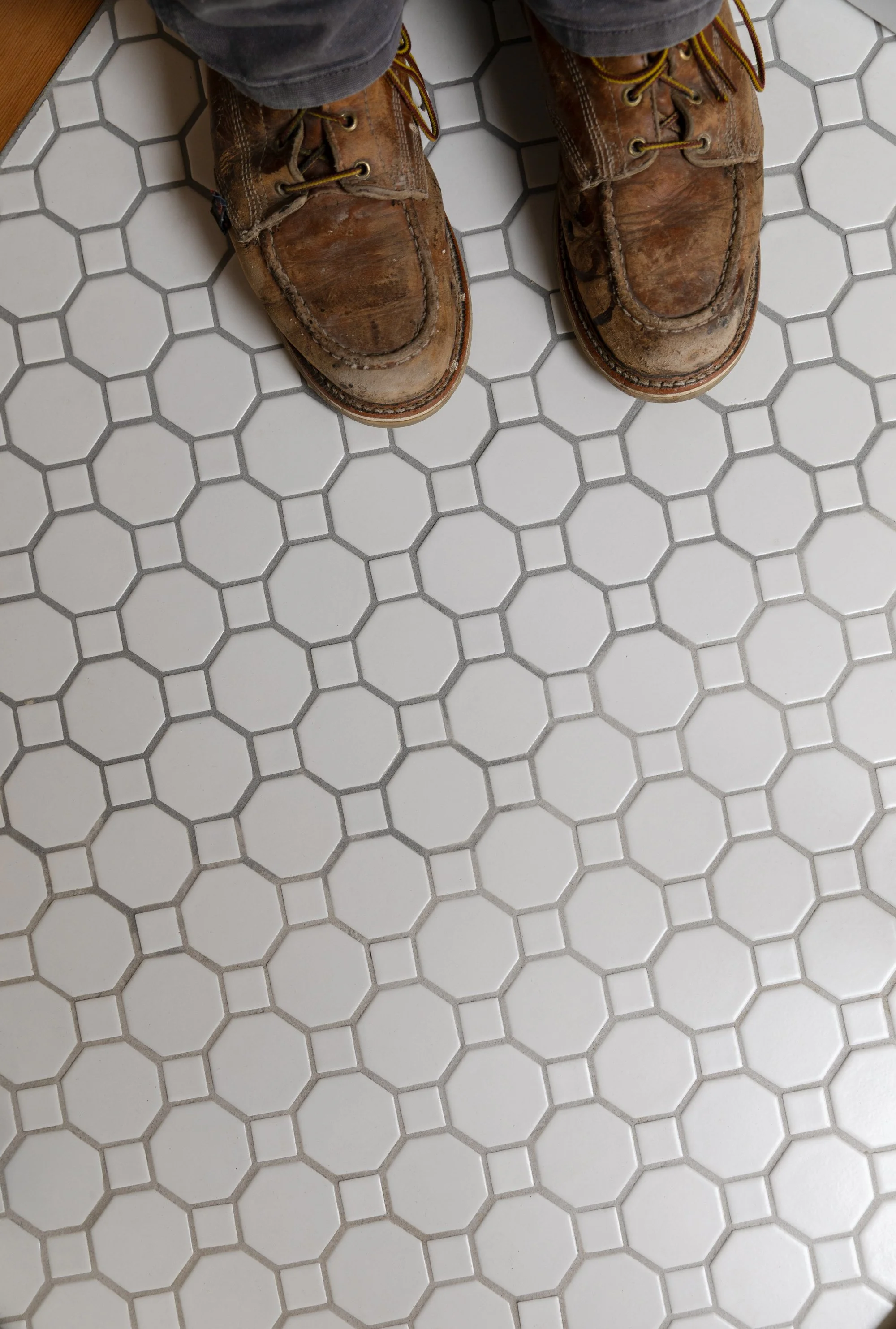 Color variation between two units of the same epoxy grout in the Hill House hall bathroom floor