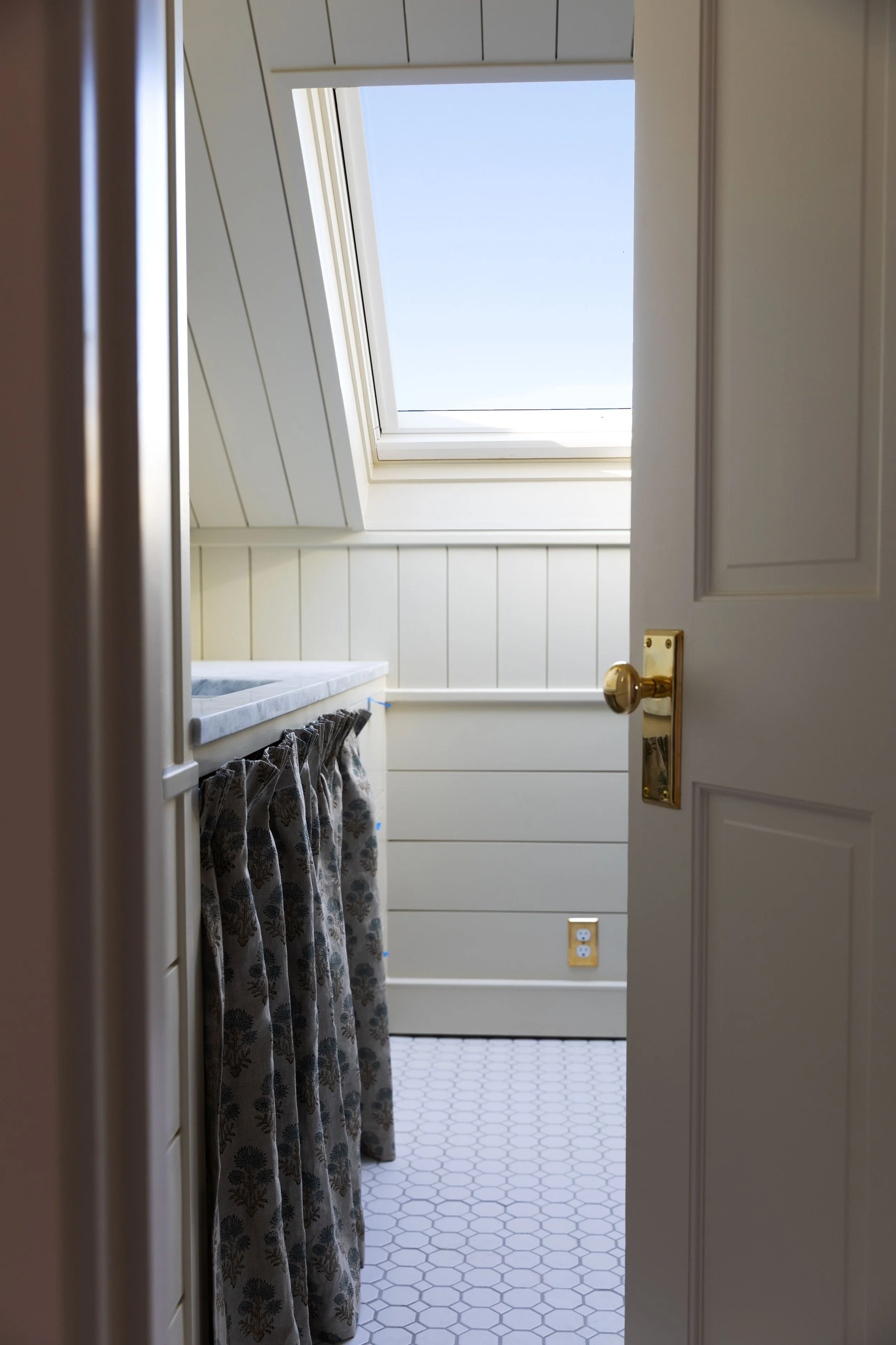 Skirted bathroom vanity in our Hill House hall bath viewed from the doorway