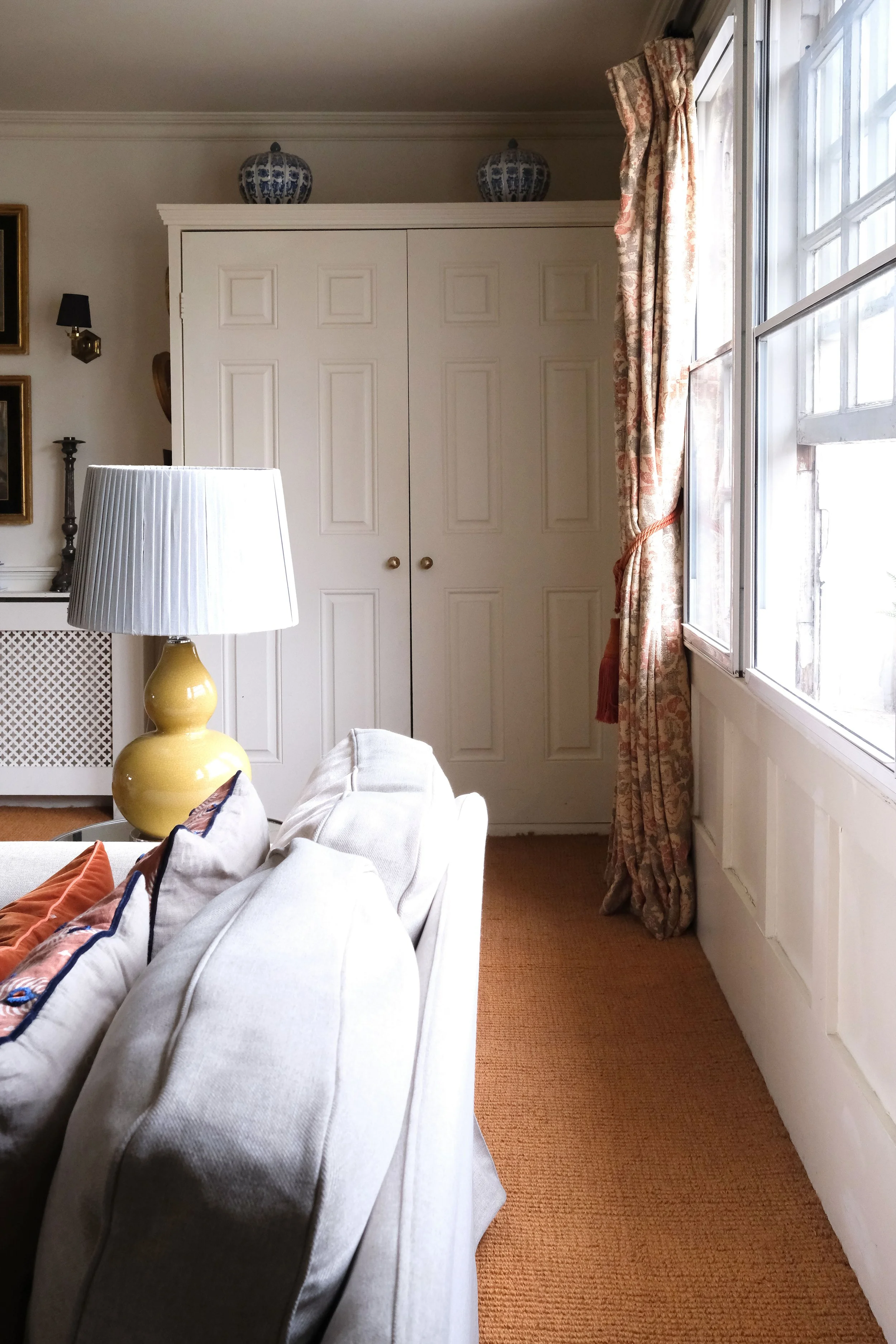 Paneled doors concealing a fold-down bed in the living room of a small Bath apartment