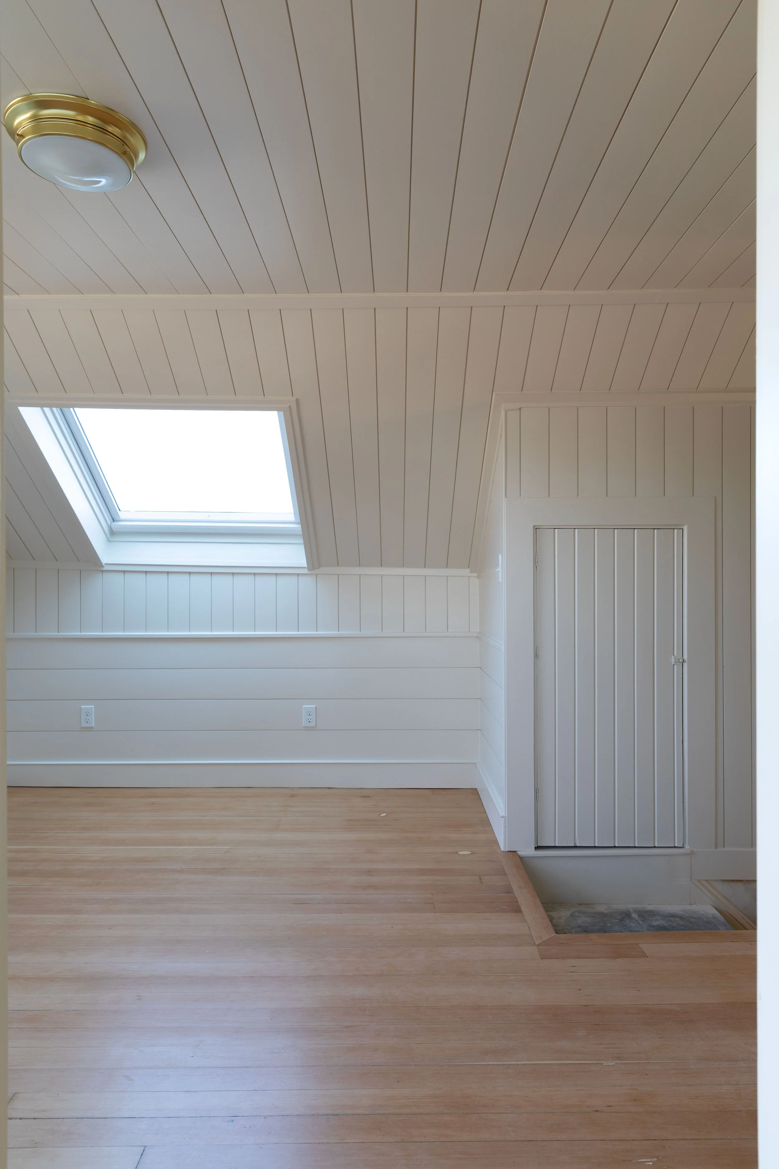 Progress on the Hill House snug with skylight, paneling, and refinished fir floors