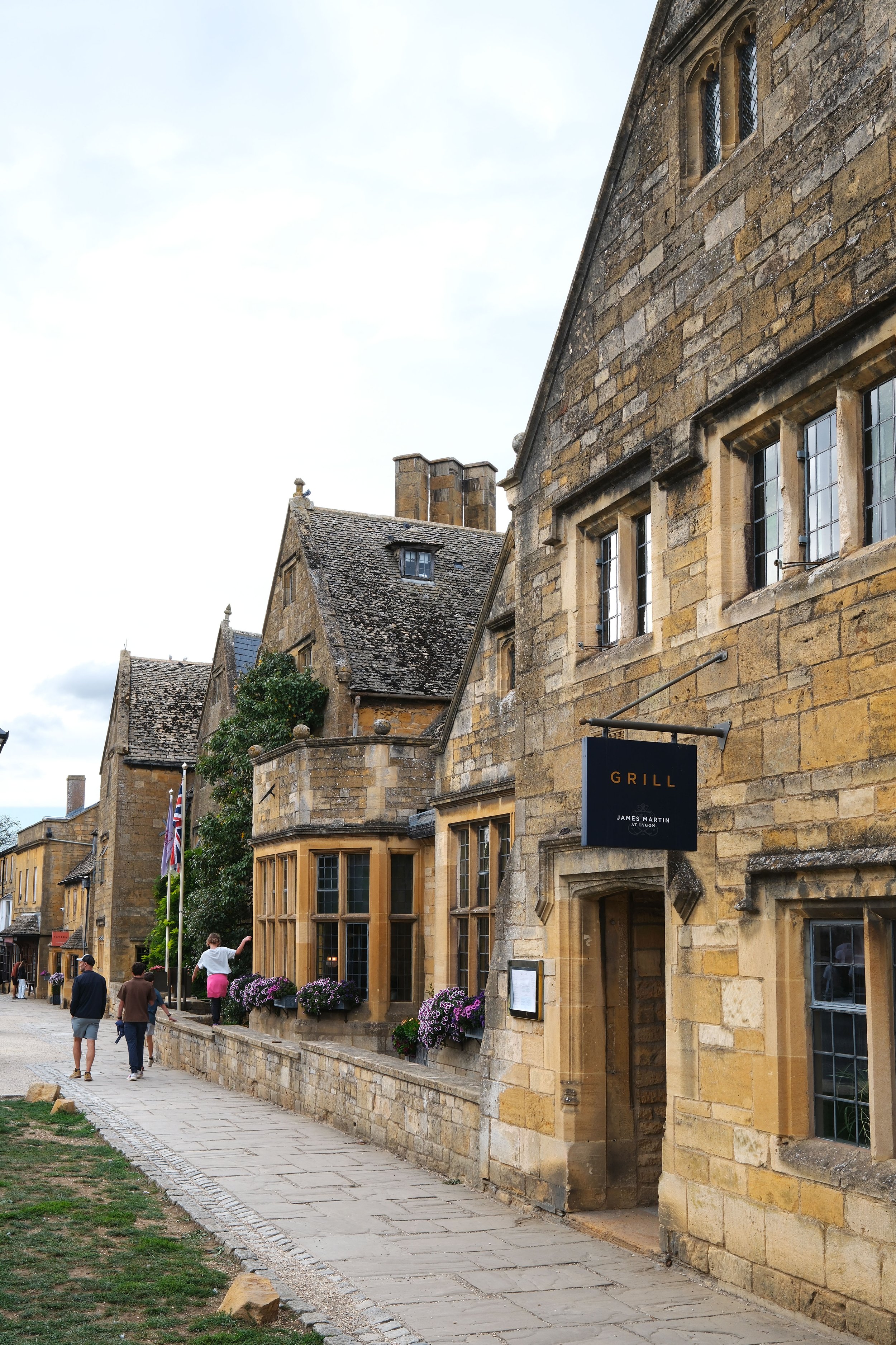 Honey-colored stone buildings along the high street in Broadway, England