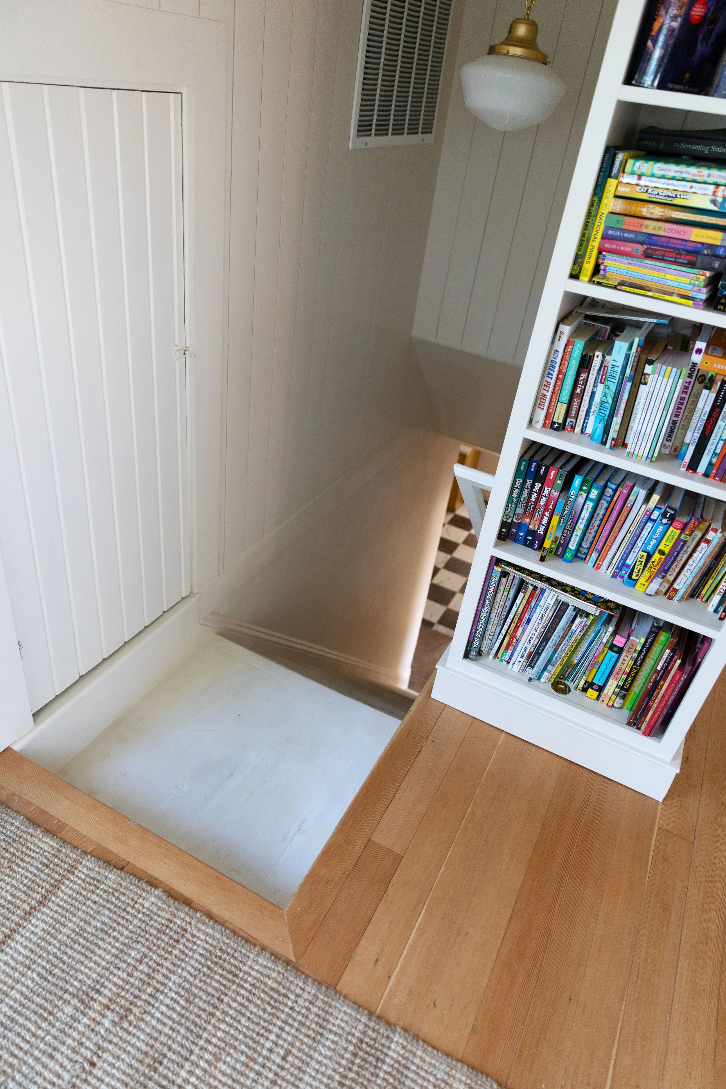 The built-in bookcase at the top of the Hill House stairs