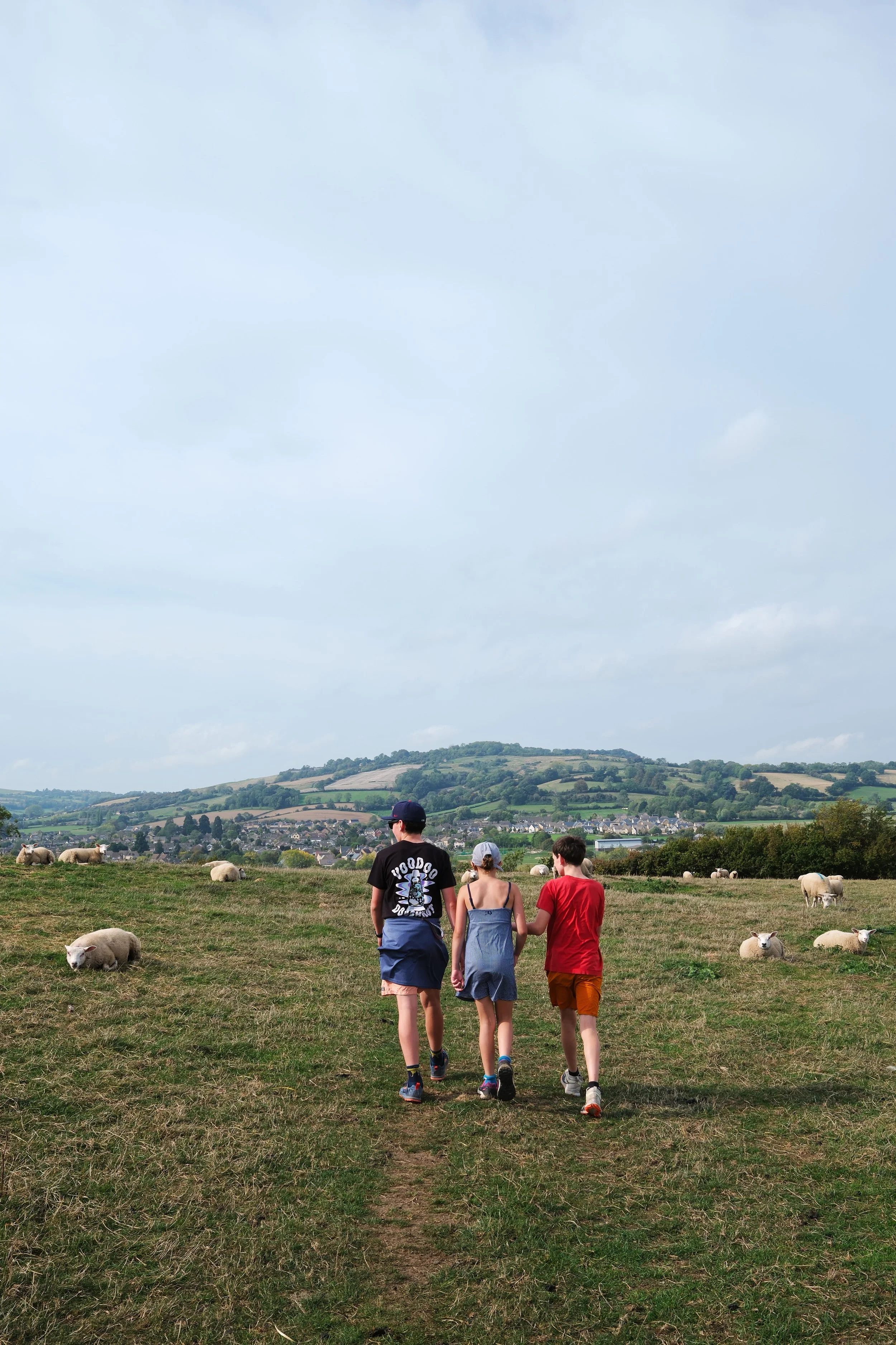Family hiking the Cotswold Way through the English countryside