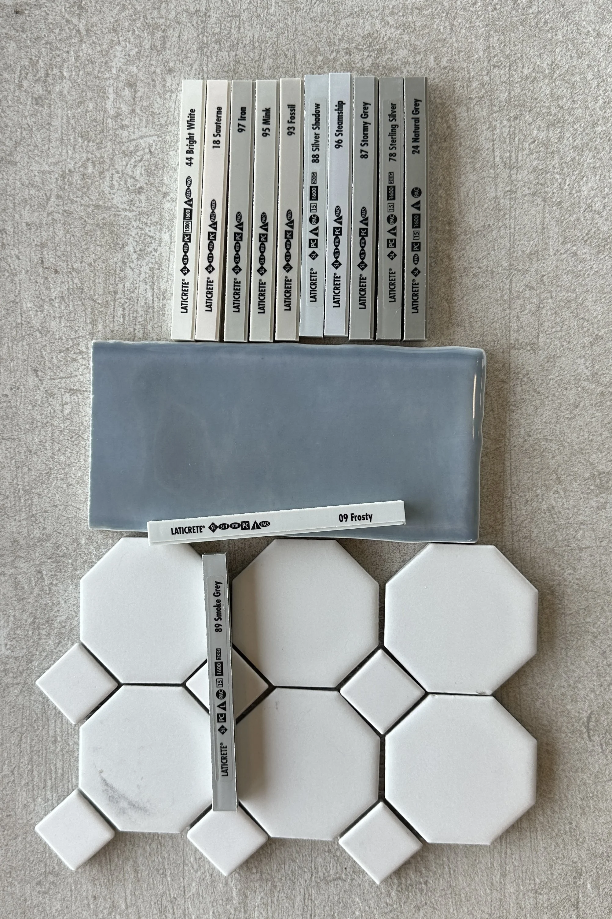 Flat lay of tile and epoxy grout color samples with grout colors labeled