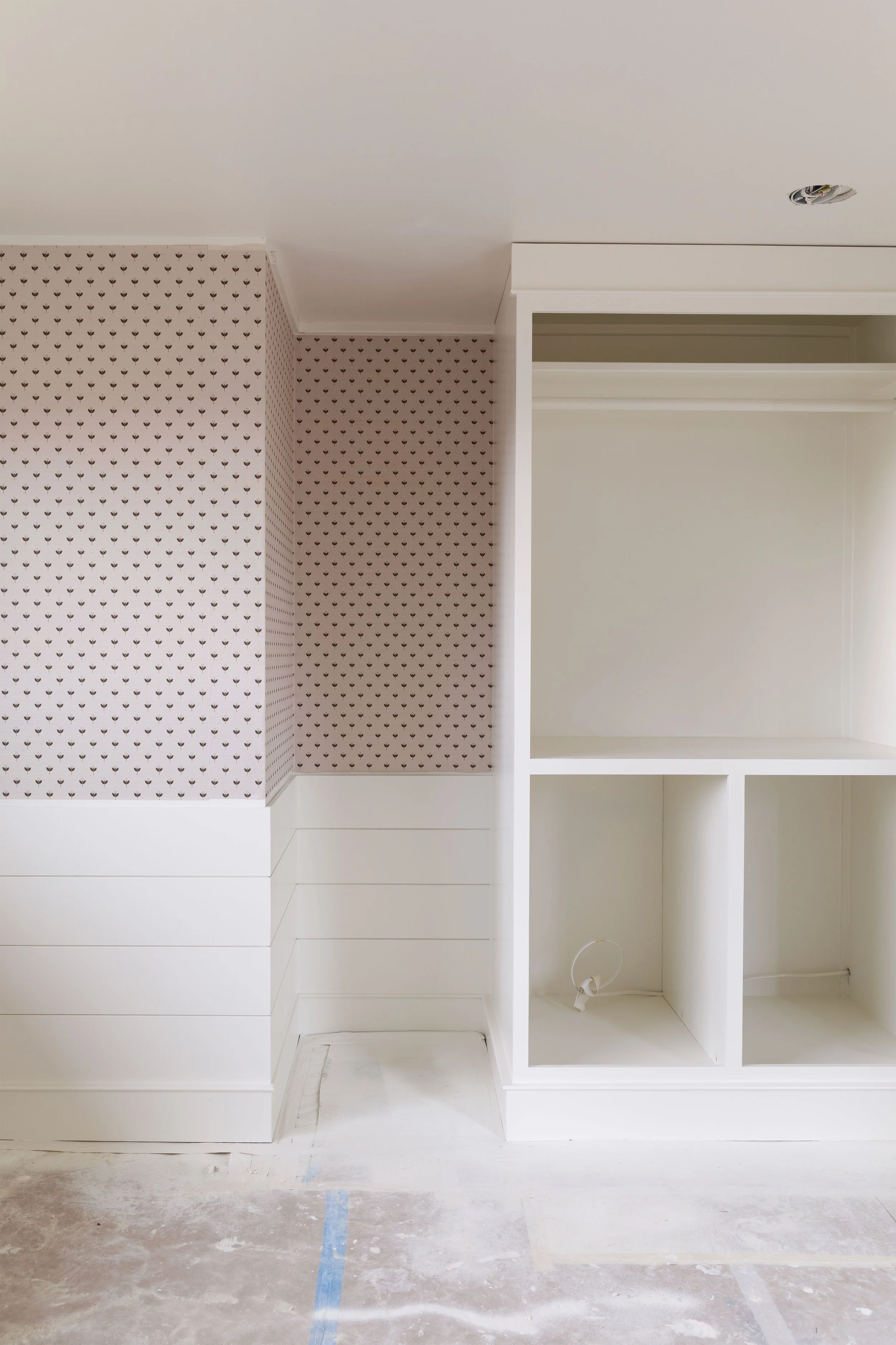 Finished grasscloth wallpaper in Daphne’s bedroom at the Hill House, showing small-scale floral print and layered texture