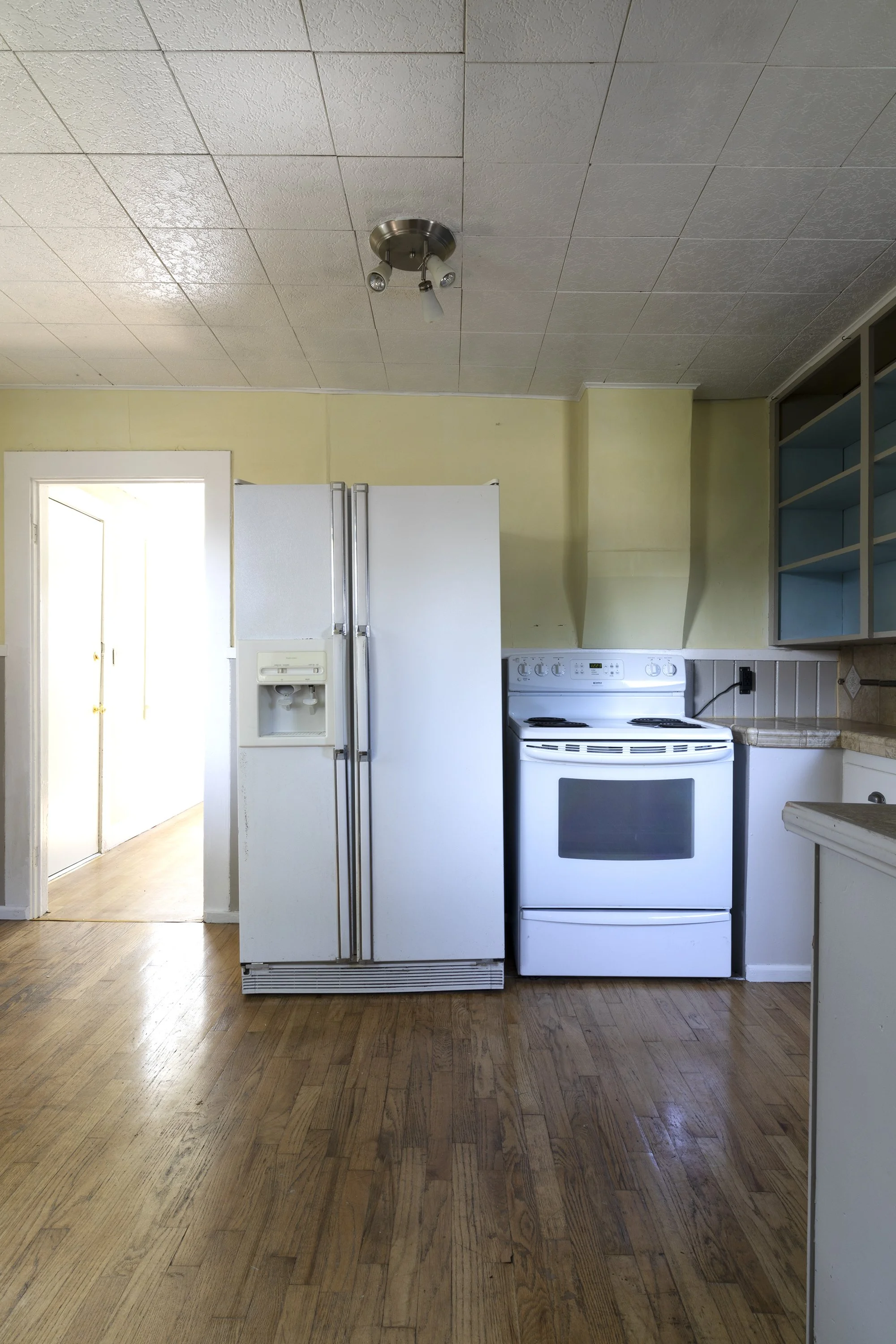 Wide view of the Poplar Cottage kitchen before remodel with eclectic finishes.