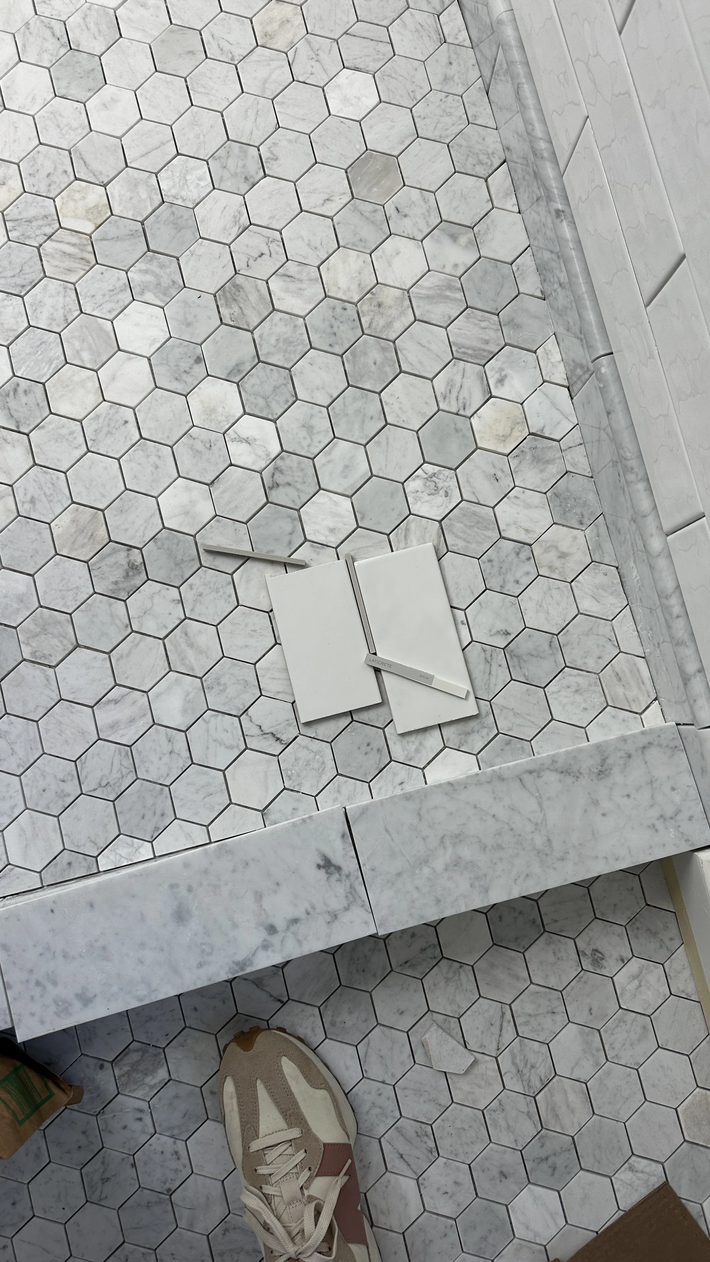 Spectralock epoxy grout color samples with white subway tile and marble hex