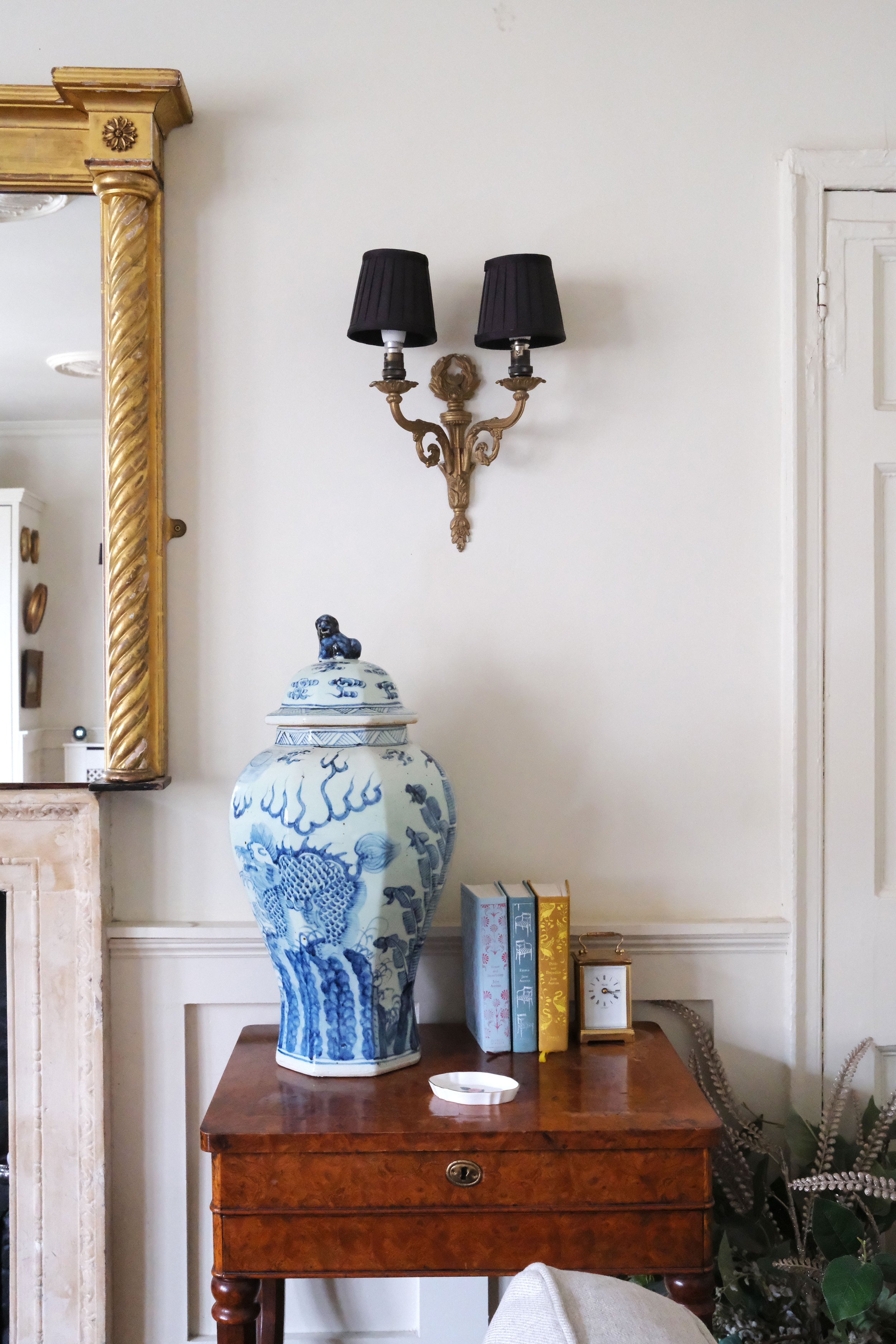 Antique furniture, patterned textiles, and vintage artwork in a Regency-style Bath apartment