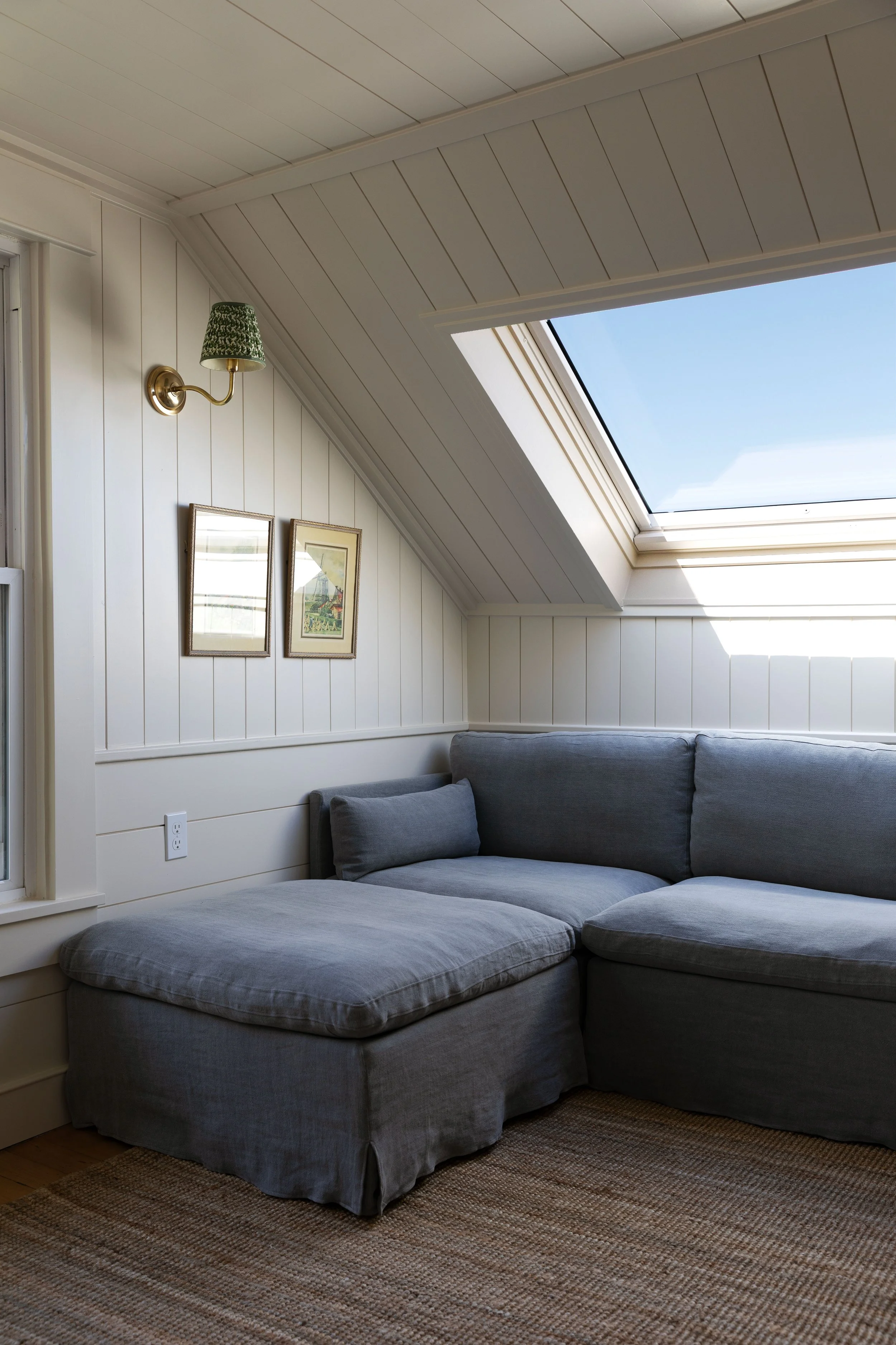 Small upstairs living room with linen sectional, jute rug, and classic layered finishes