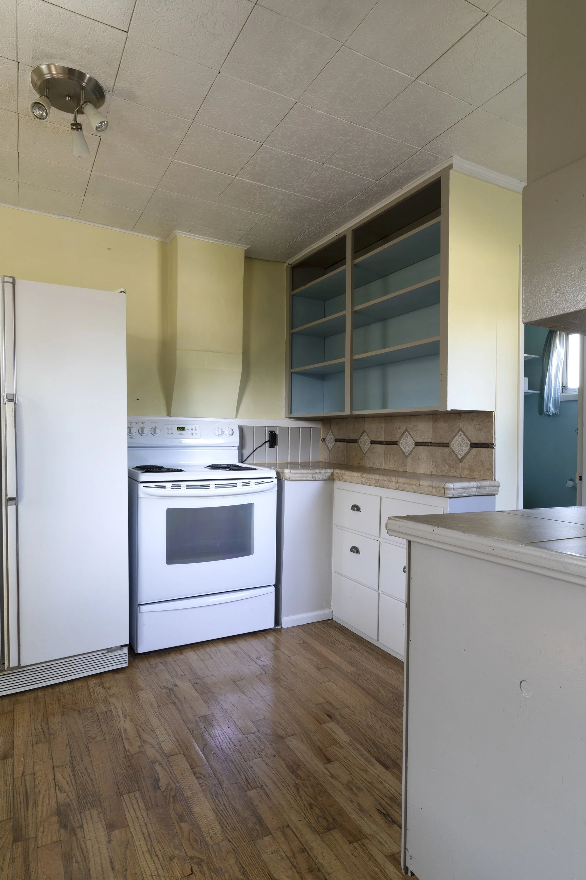 Poplar Cottage kitchen before renovation with old appliances and inefficient layout.