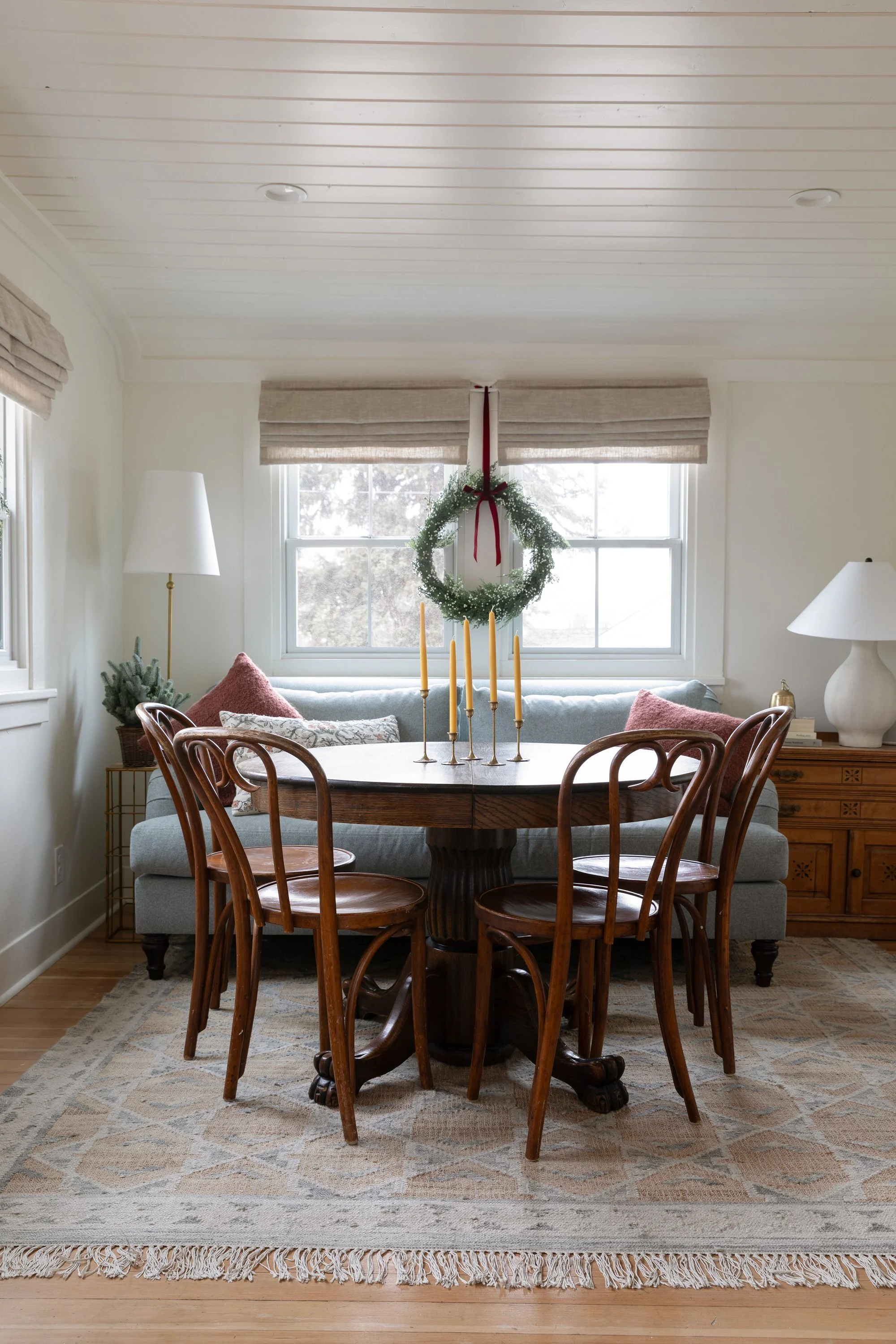 Poplar Cottage dining room decorated for Christmas with candles and a window wreath