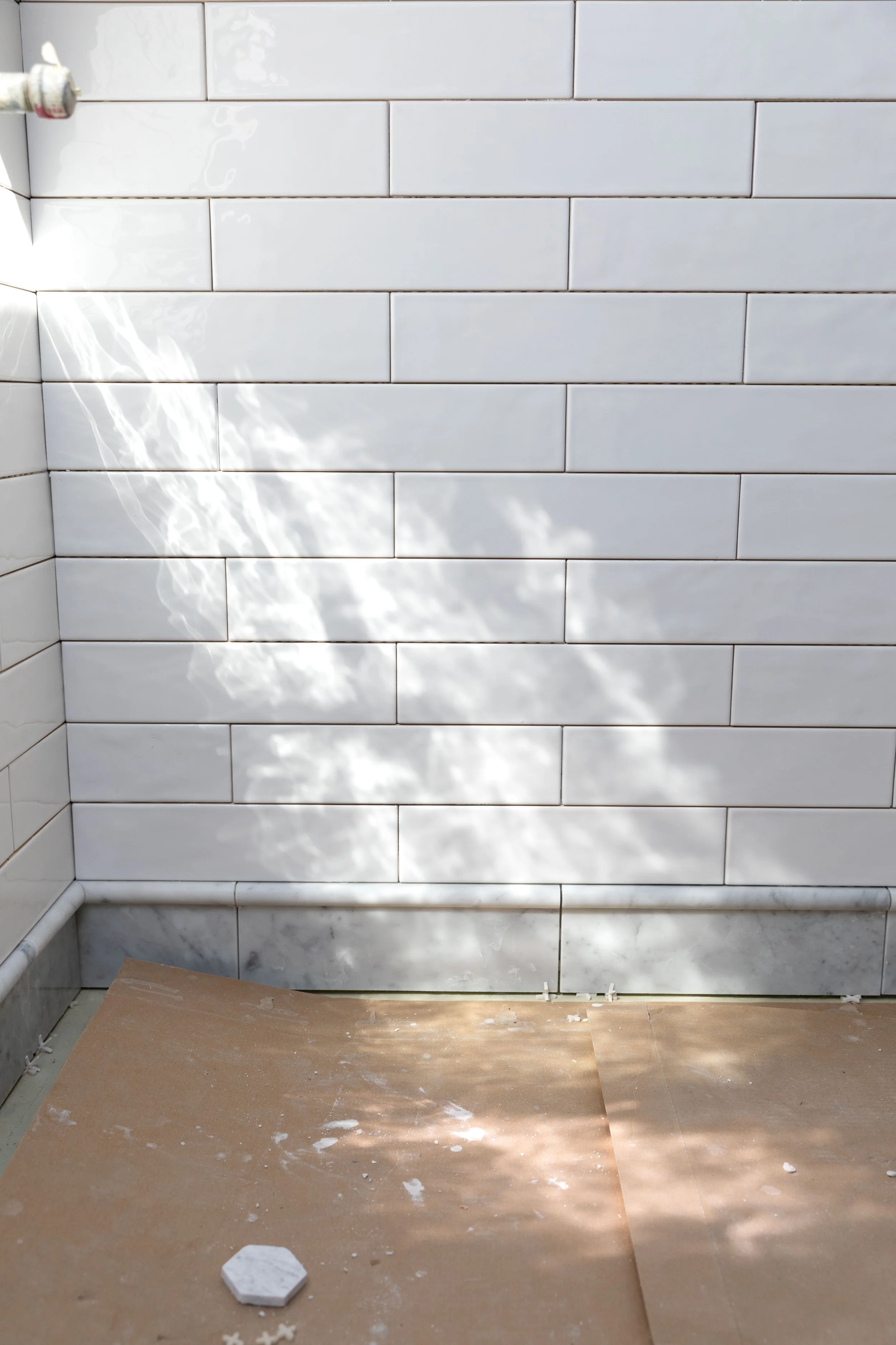 White subway tile and marble base in the ensuite bathroom