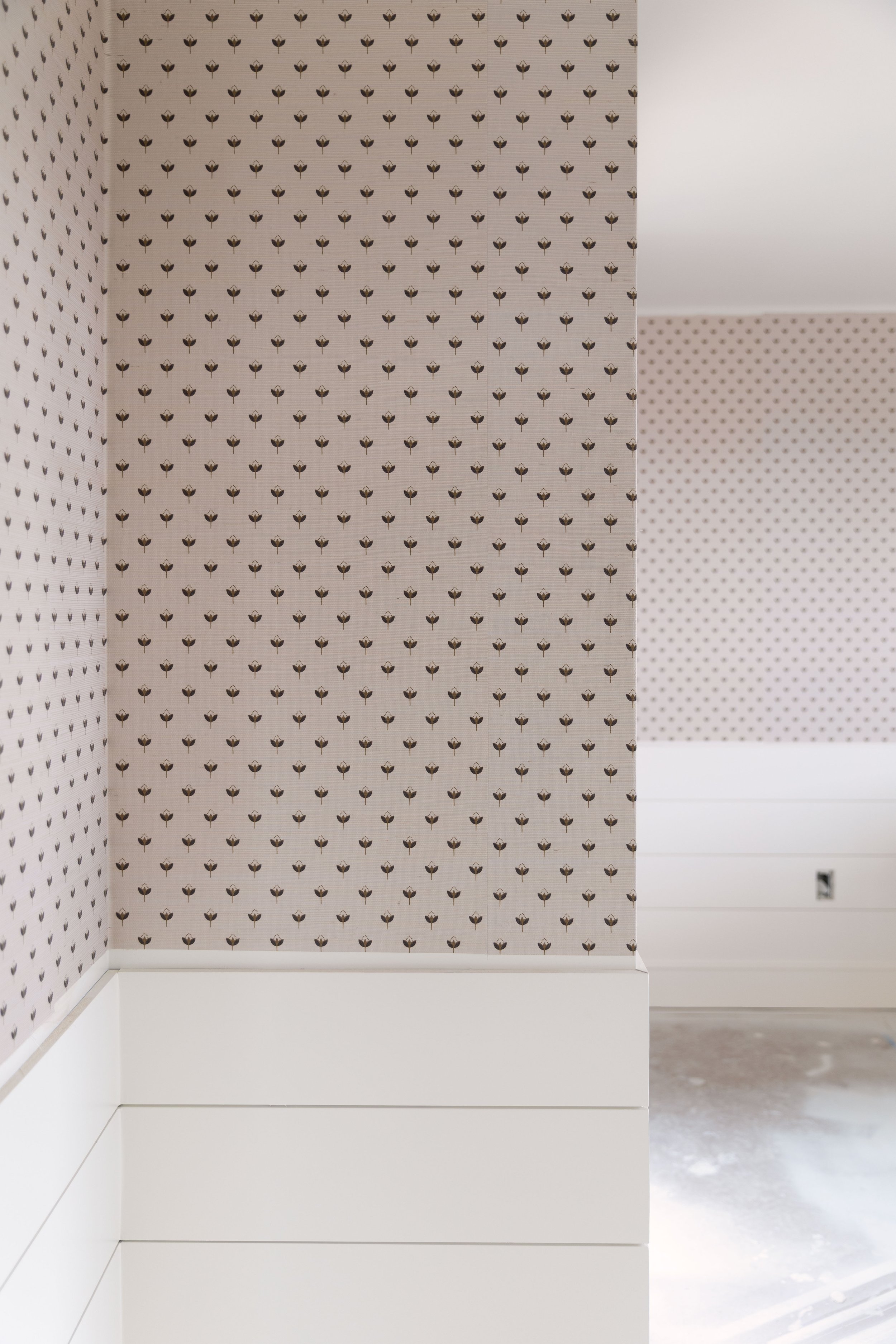 Grasscloth wallpaper installation at an inside and outside corner with extra adhesive applied