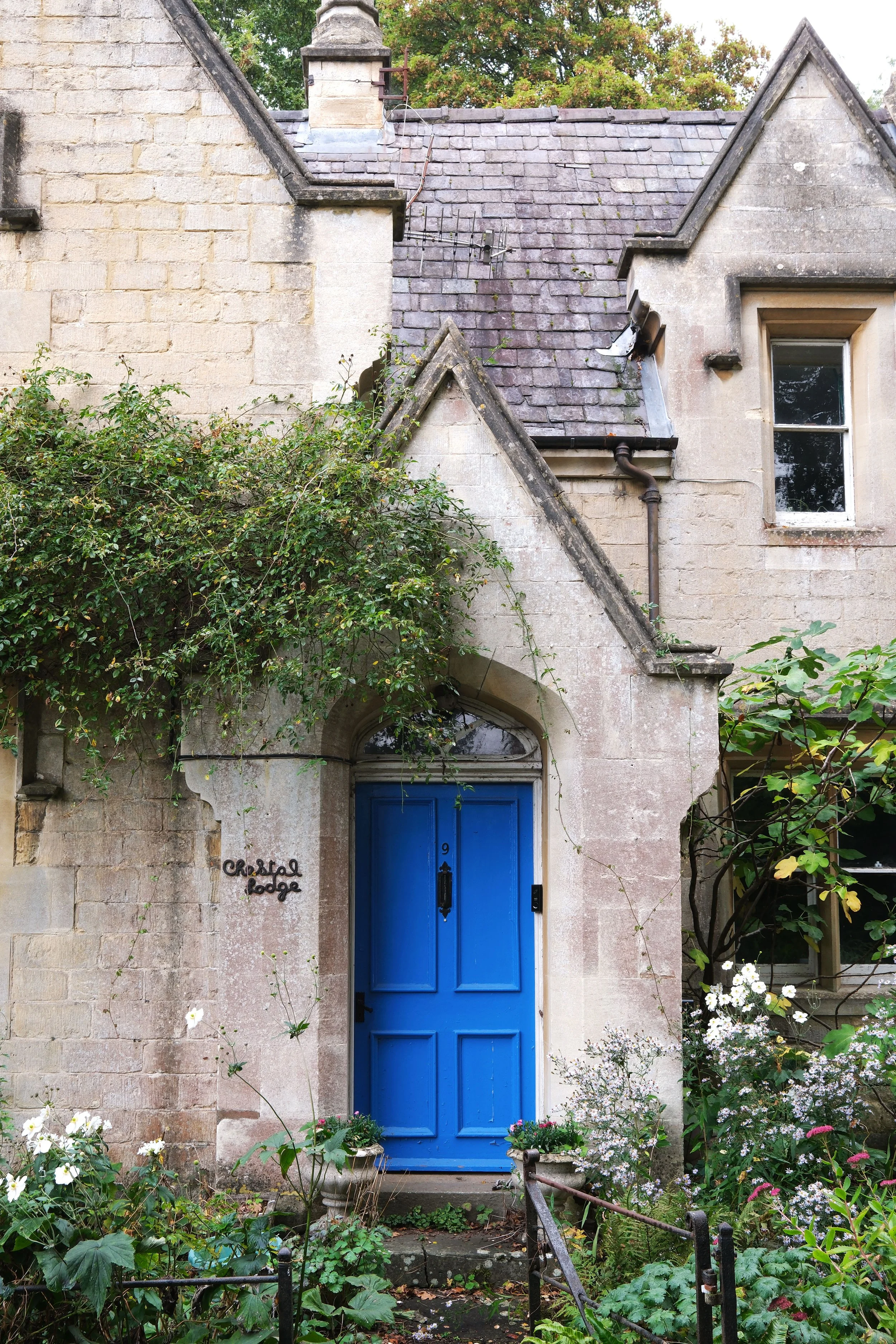 A blue door in stone cottage near Dursley along the Cotswold Way trail