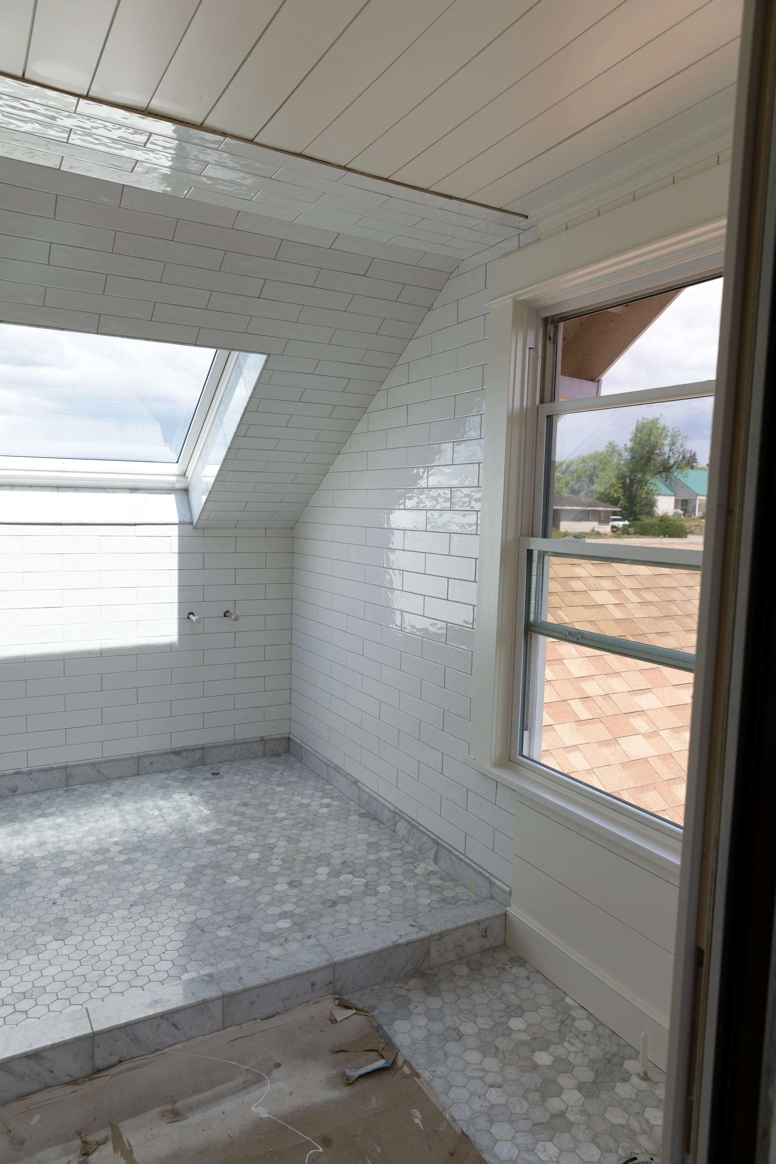 Latictrete Spectralock epoxy grout in Iron on marble hex floors and white subway walls