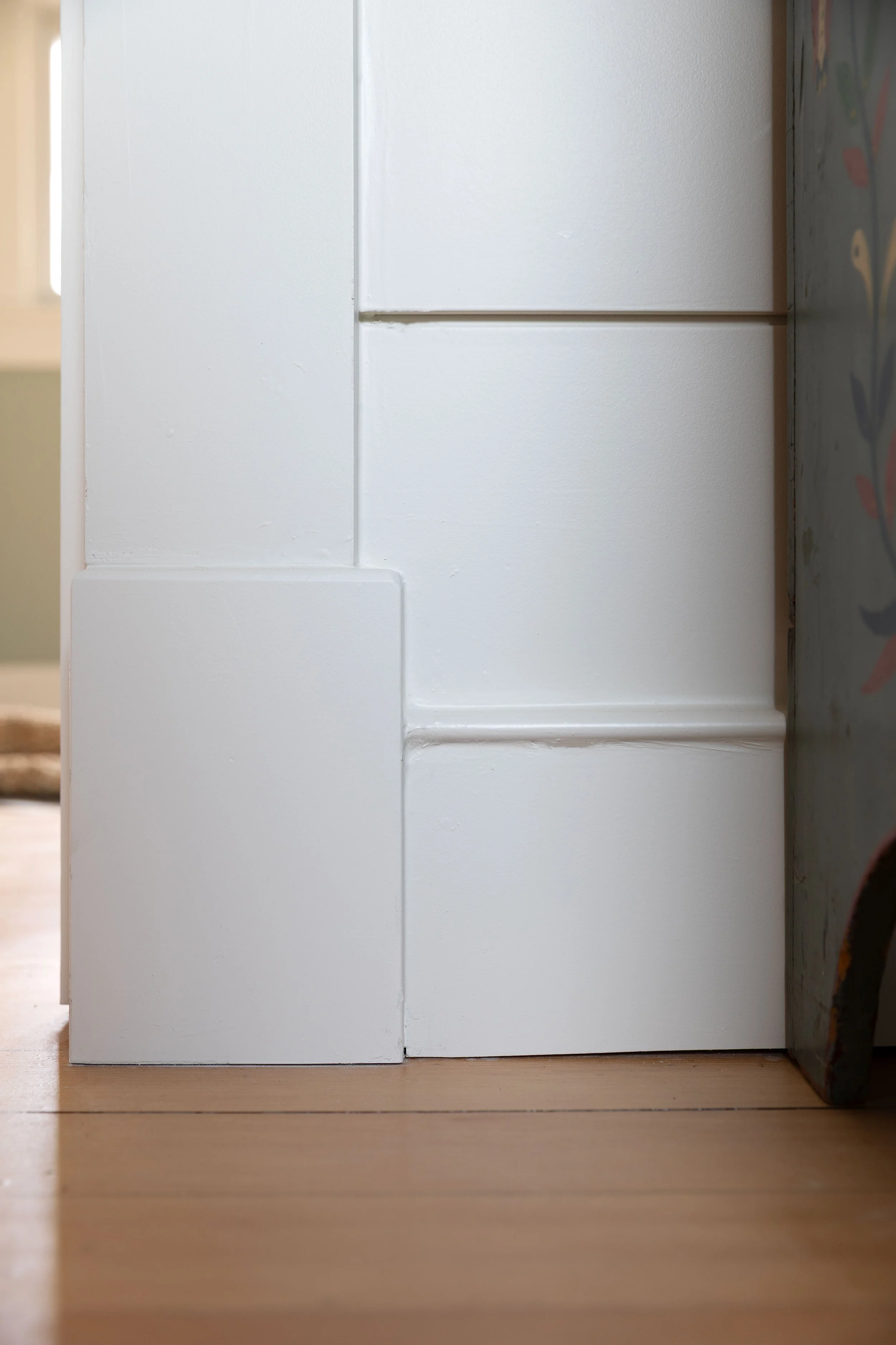 Close up of plinth block, base, and wall paneling detail in the Hill House renovation