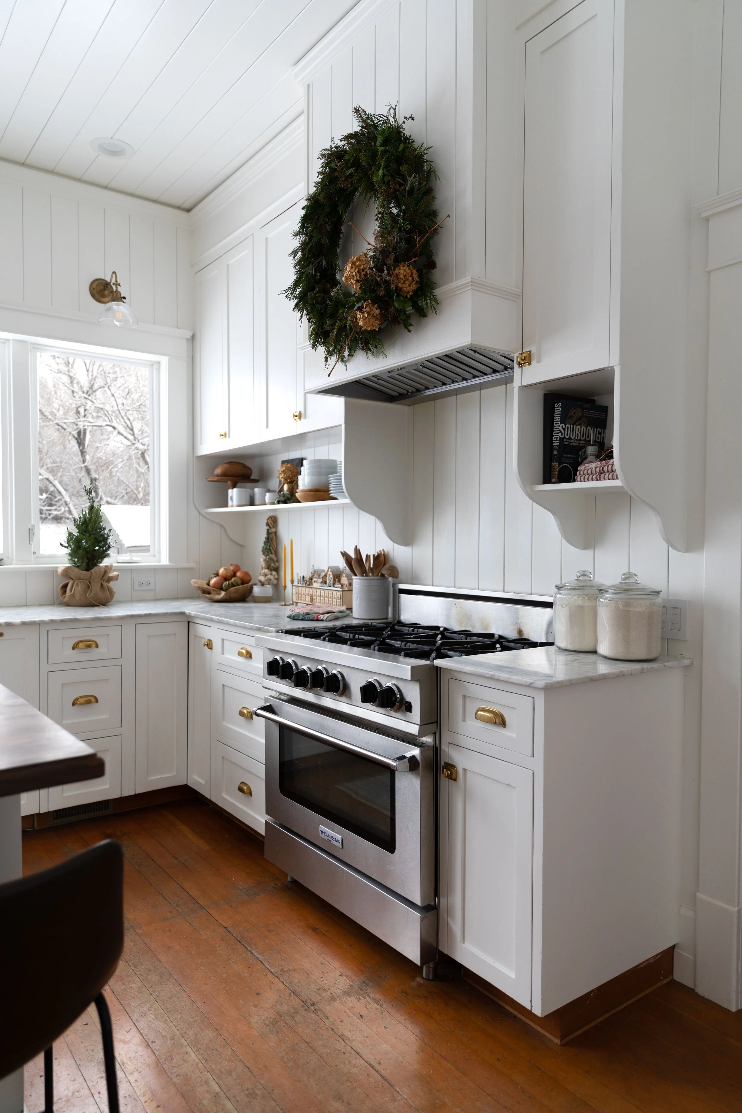 white, country kitchen decorated for holidays with natural wreath
