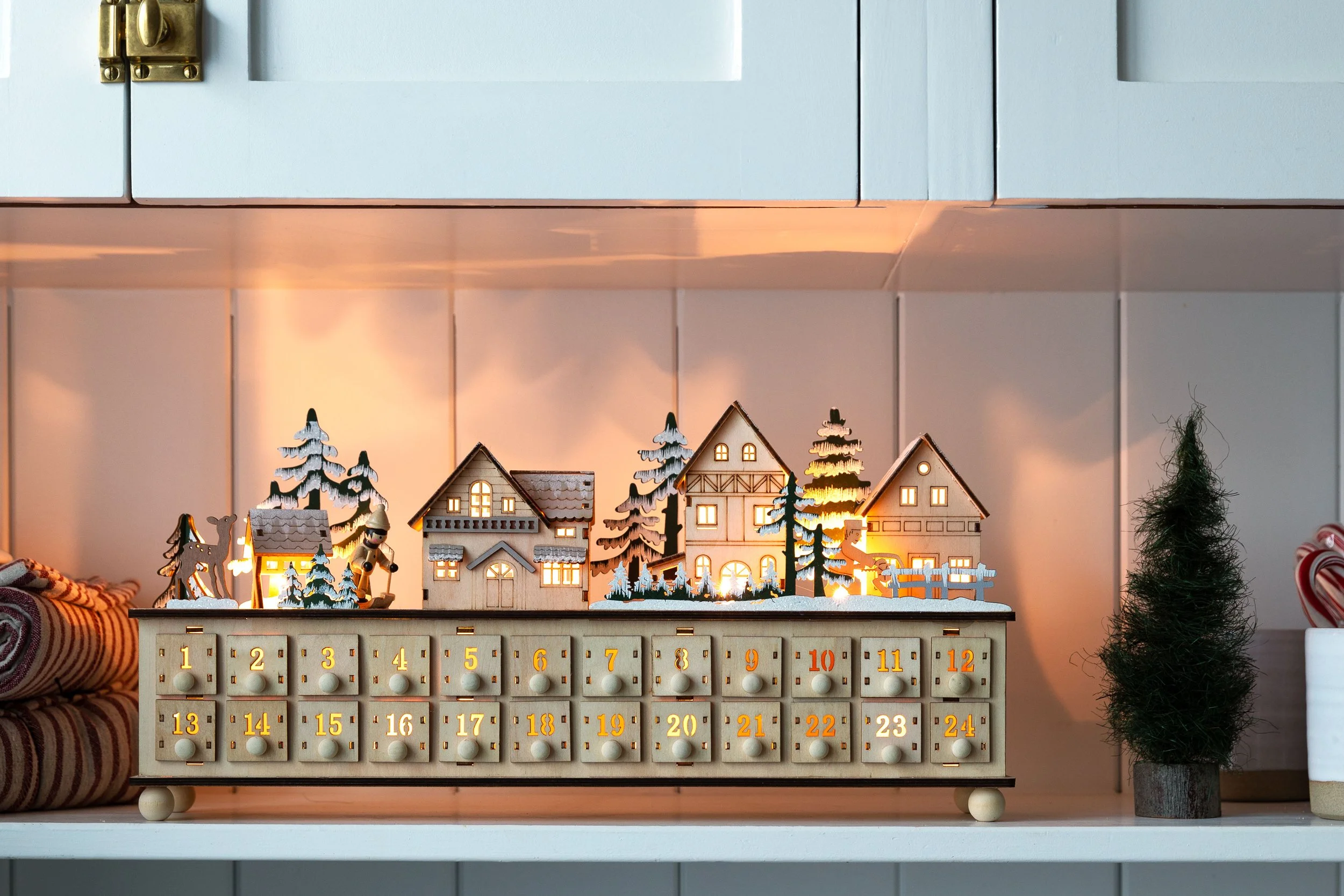 a cute advent calendar on an open shelf in the Farmhouse kitchen.
