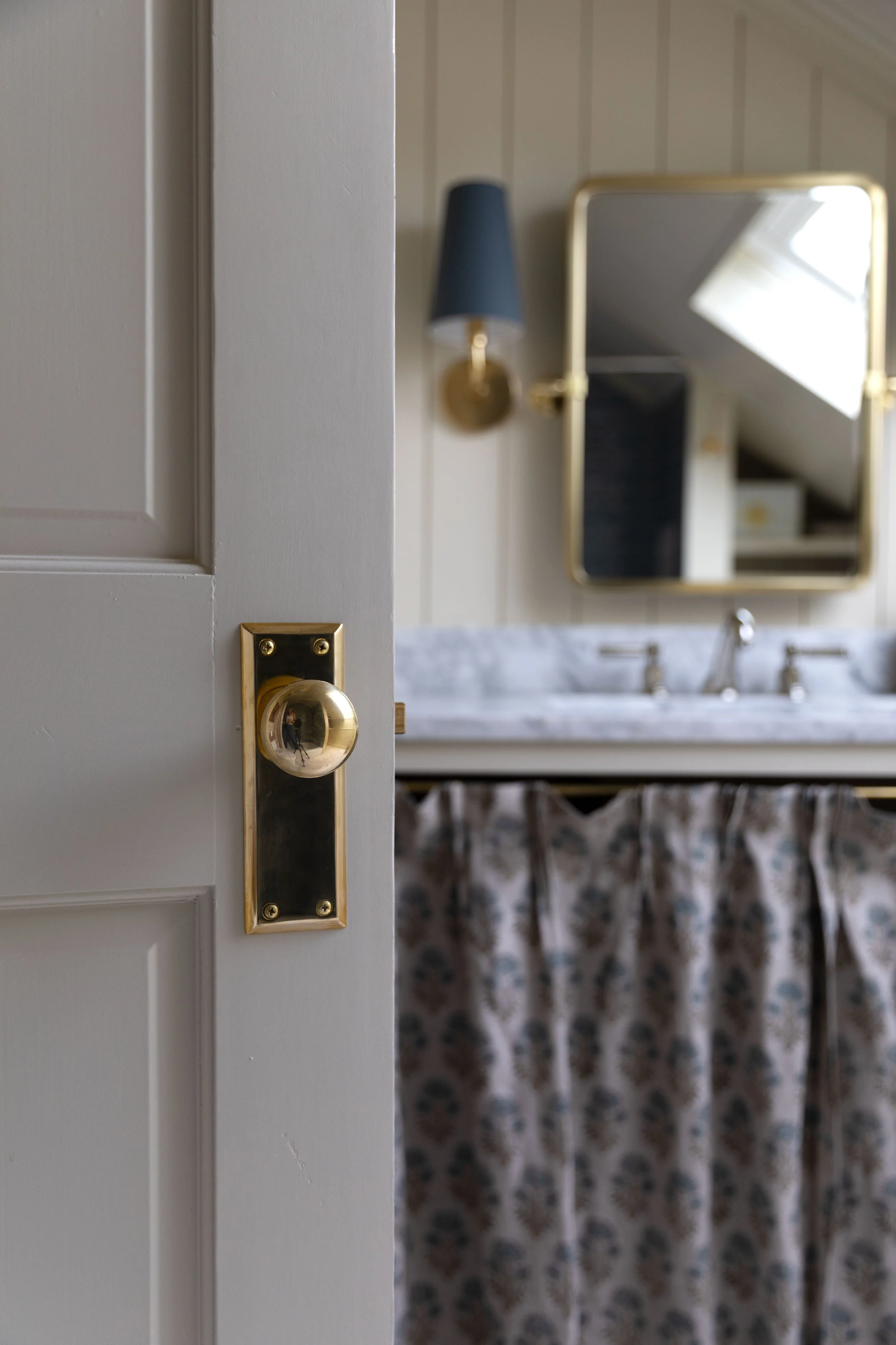 Unlacquered brass doorknob after polishing, with the original bright brass finish restored