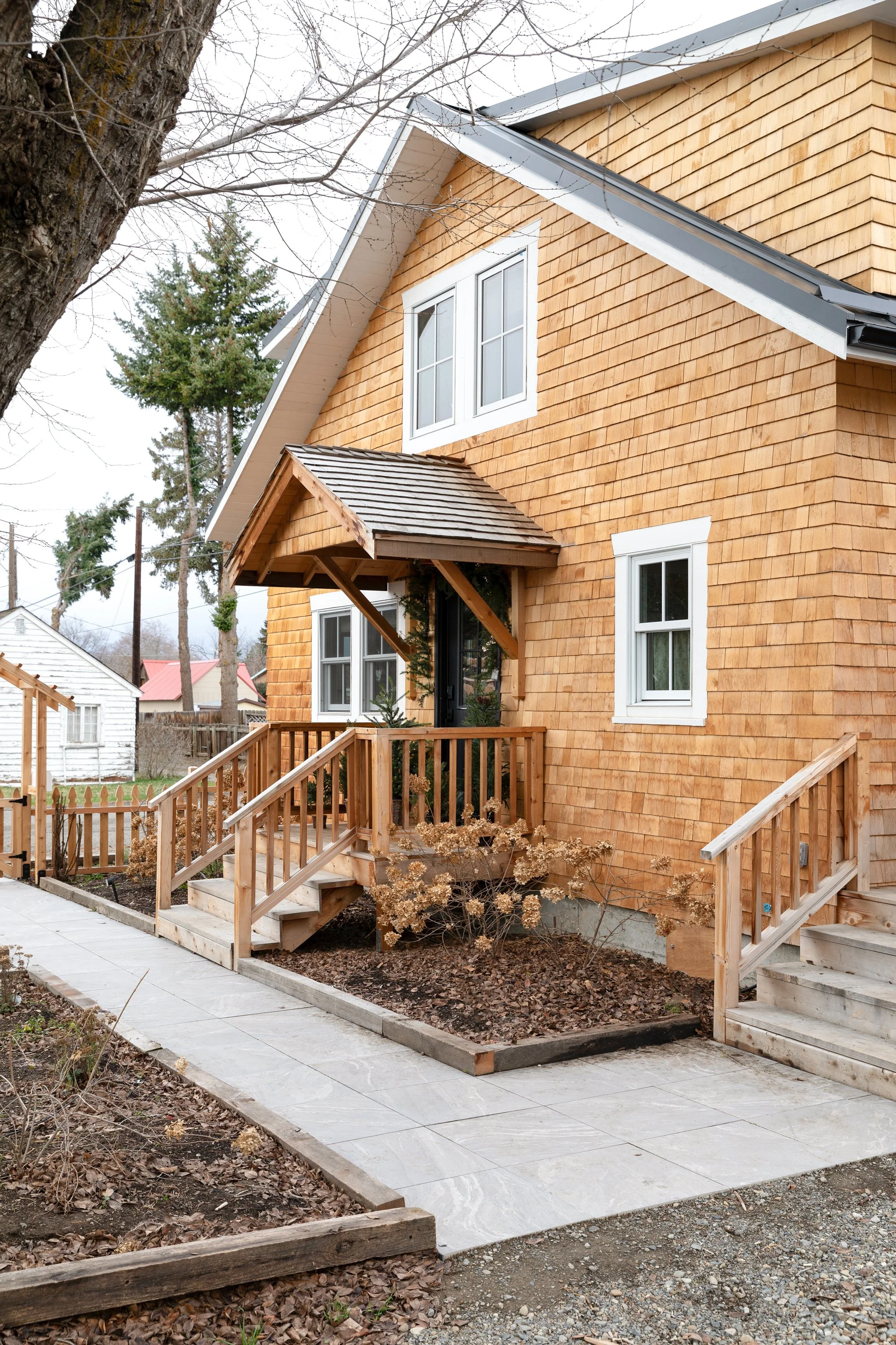 Poplar Cottage front exterior styled for winter with cedar siding and holiday greenery