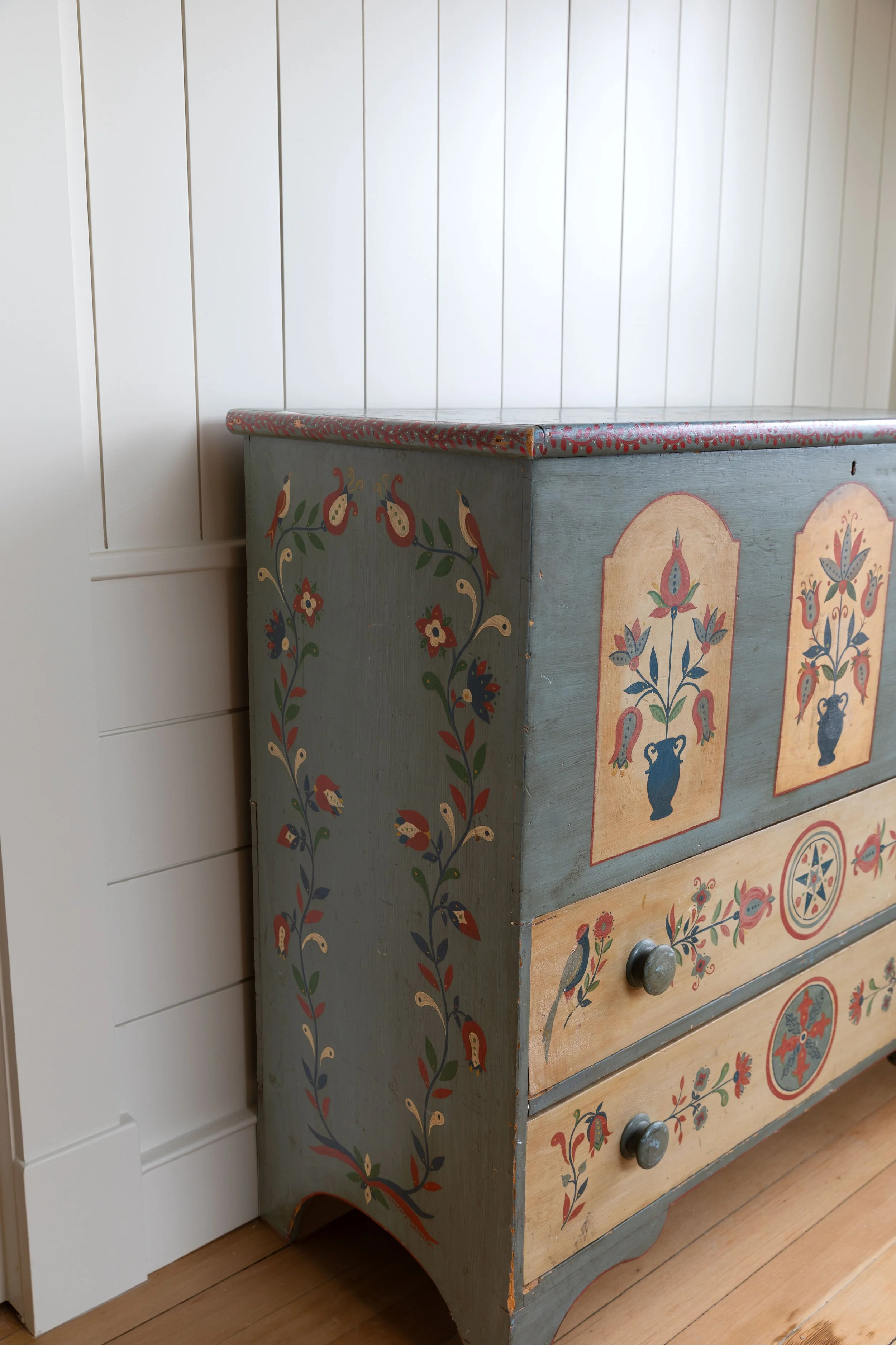 Scrolling floral motif on hand painted dresser in the Hill House