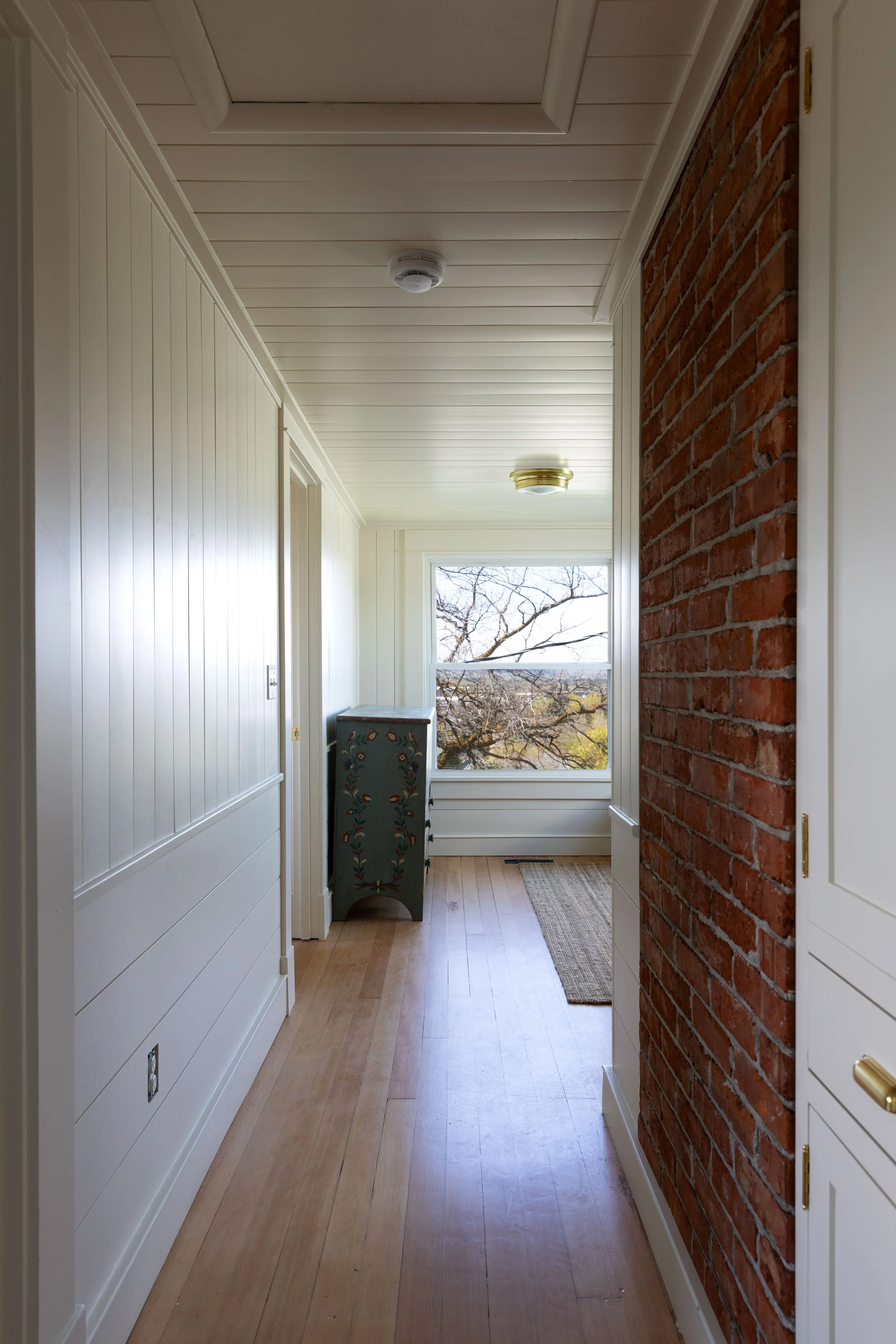 Small upstairs snug and hallway with low ceilings and wall paneling