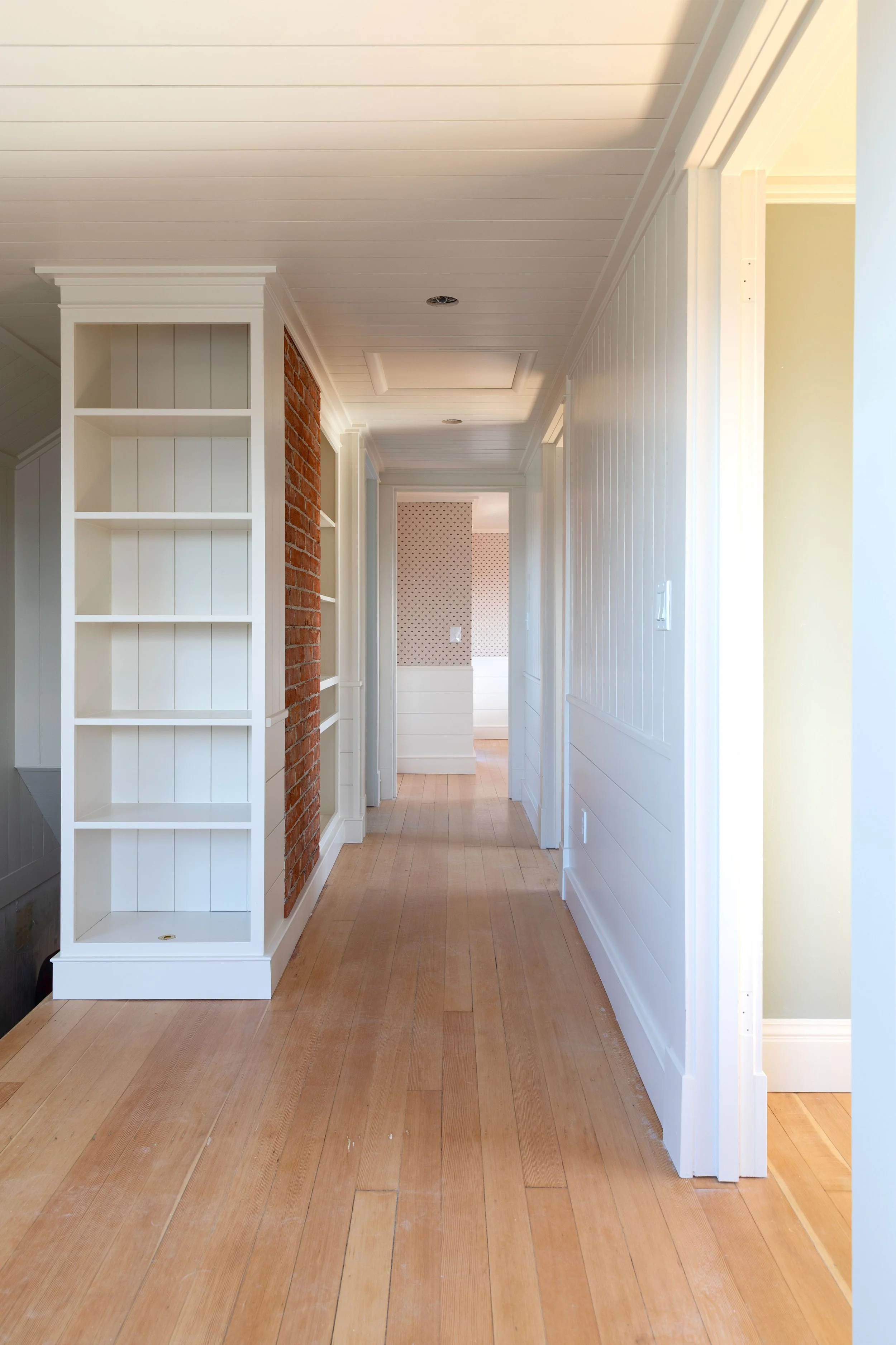 Nickel gap wall paneling on walls and ceiling of the Hill House upstairs hallway