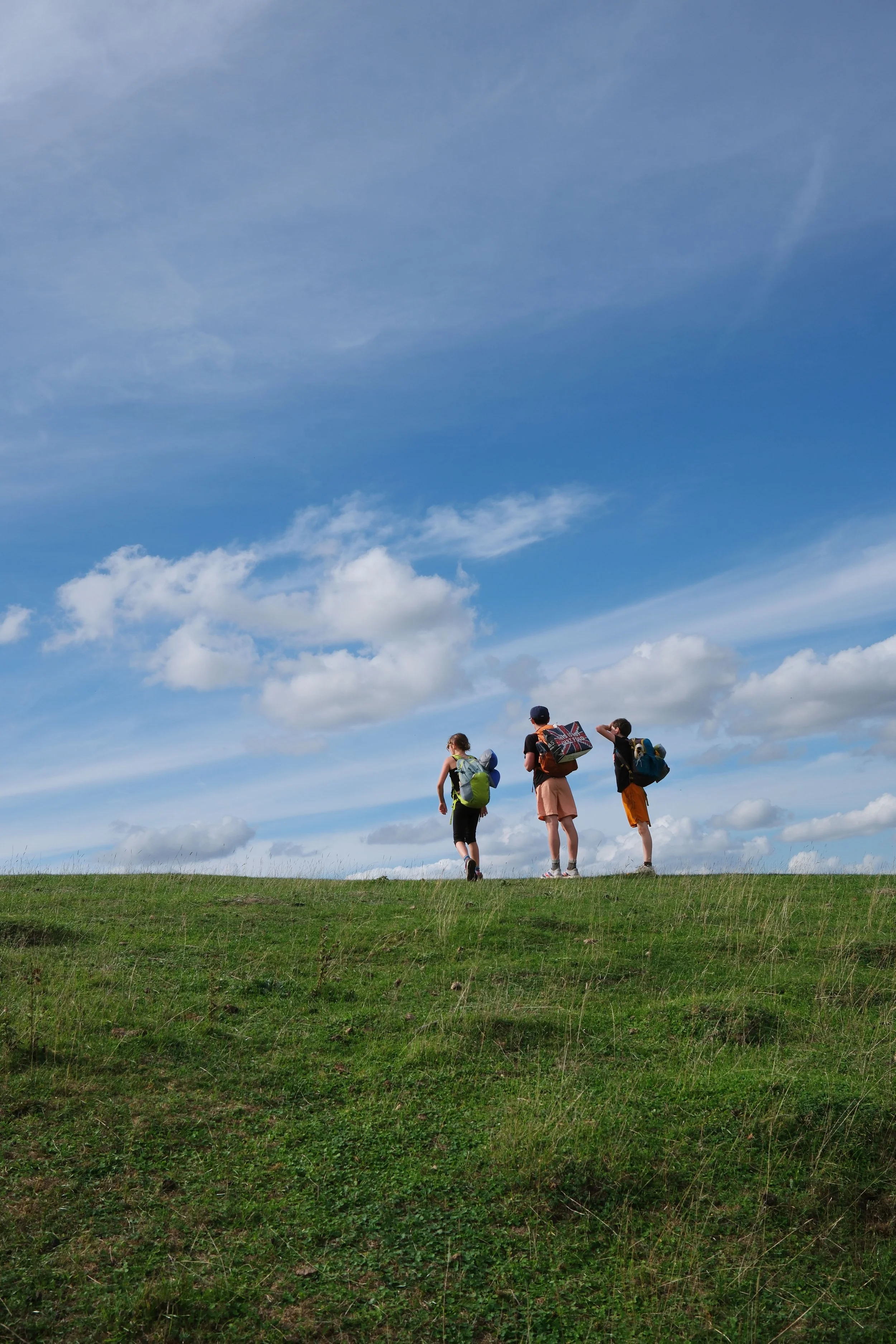 Family hiking the Cotswold Way through the English countryside