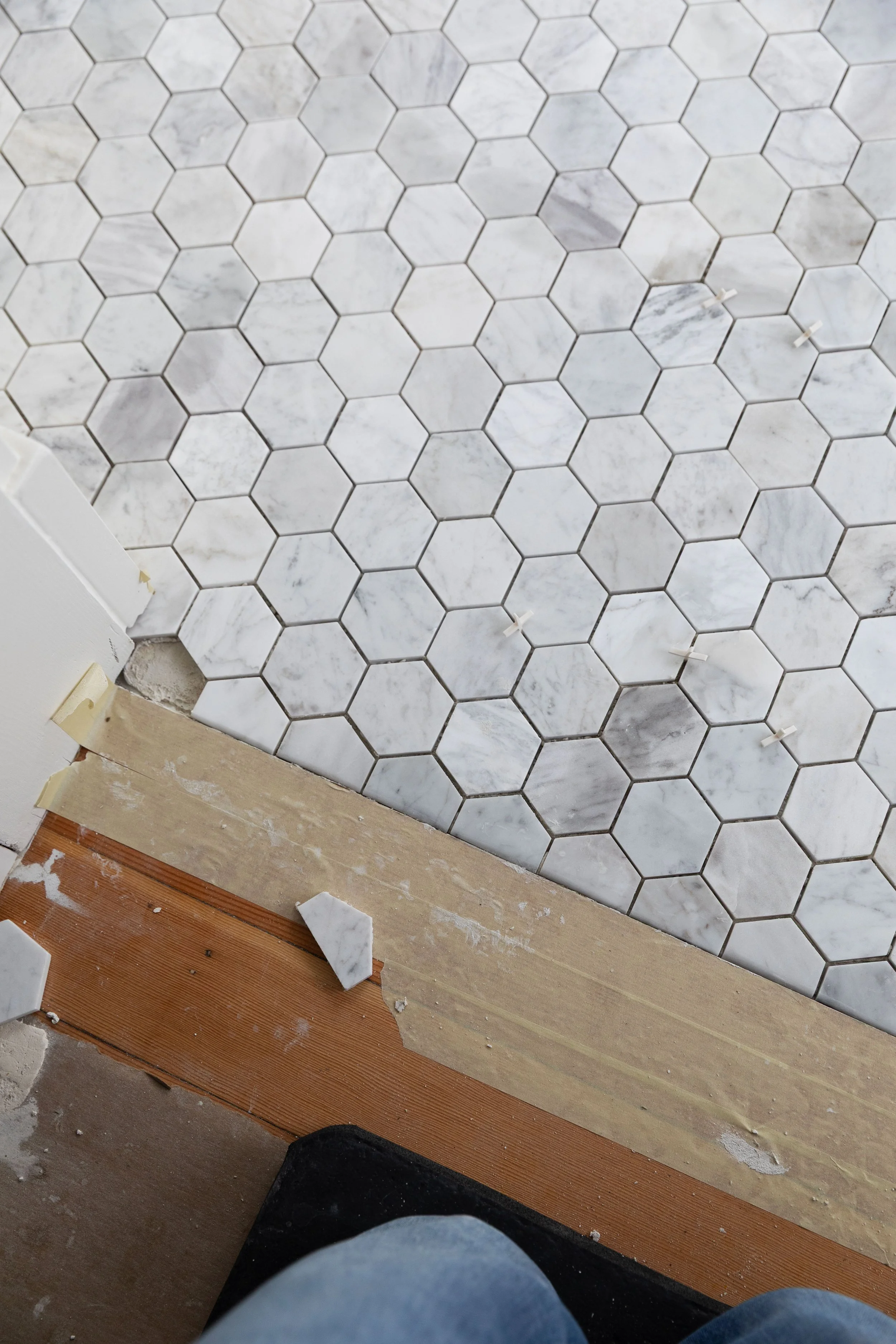 The last tile piece for our marble hex floors in the ensuite bathroom