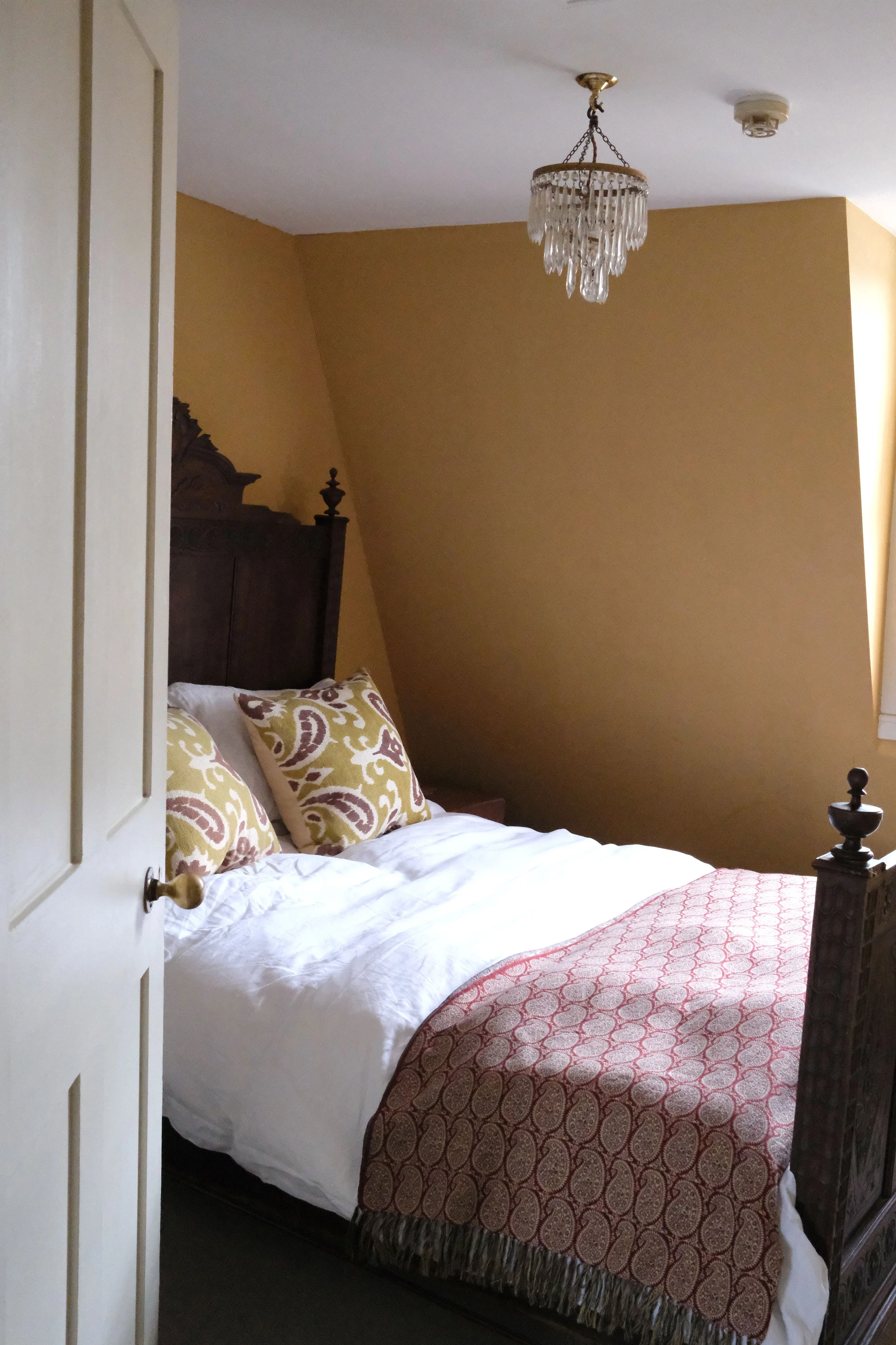 yellow-bedroom-regency-apartment-bath.jpg