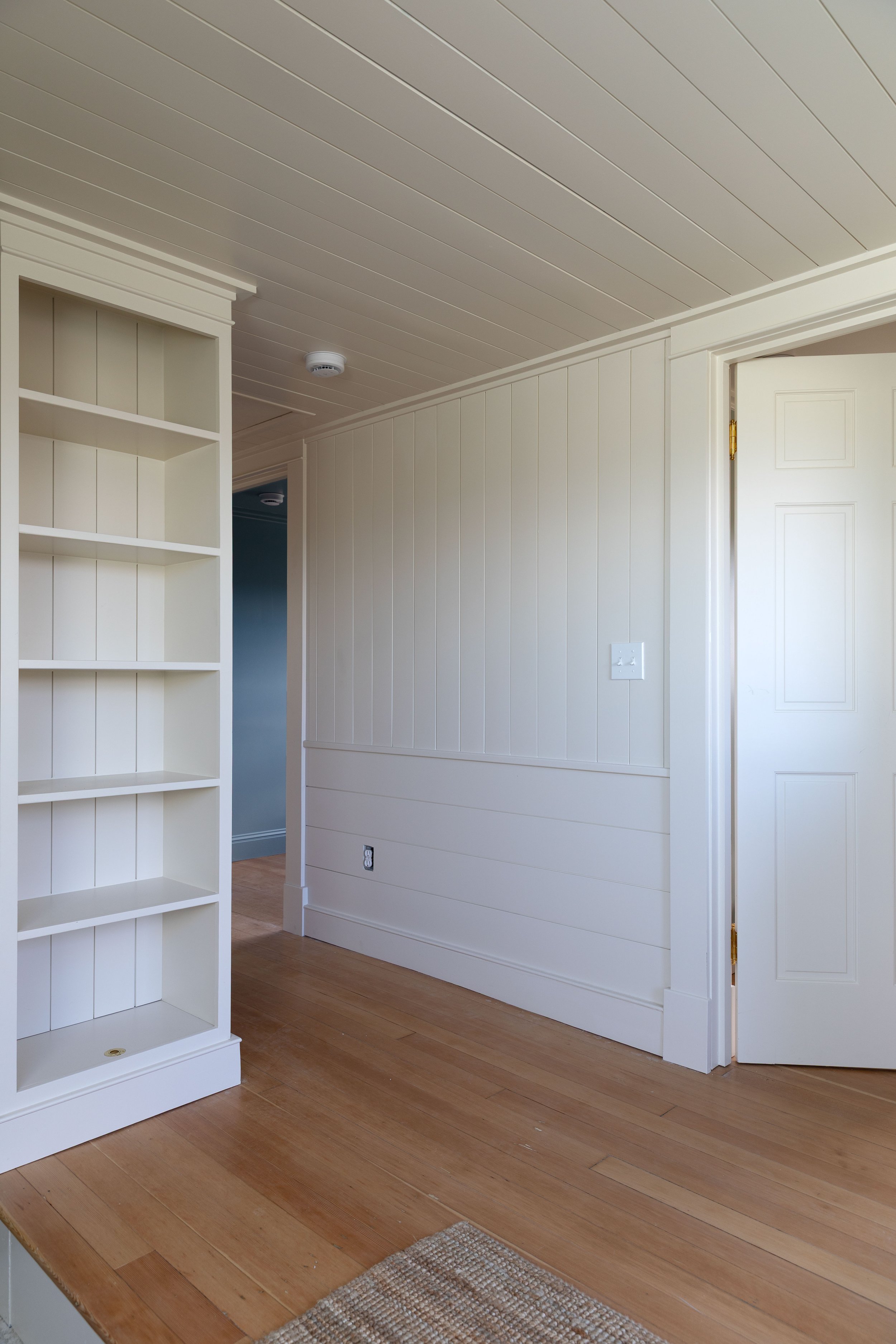 Vertical paneling in a low ceiling room to help draw the eye upward
