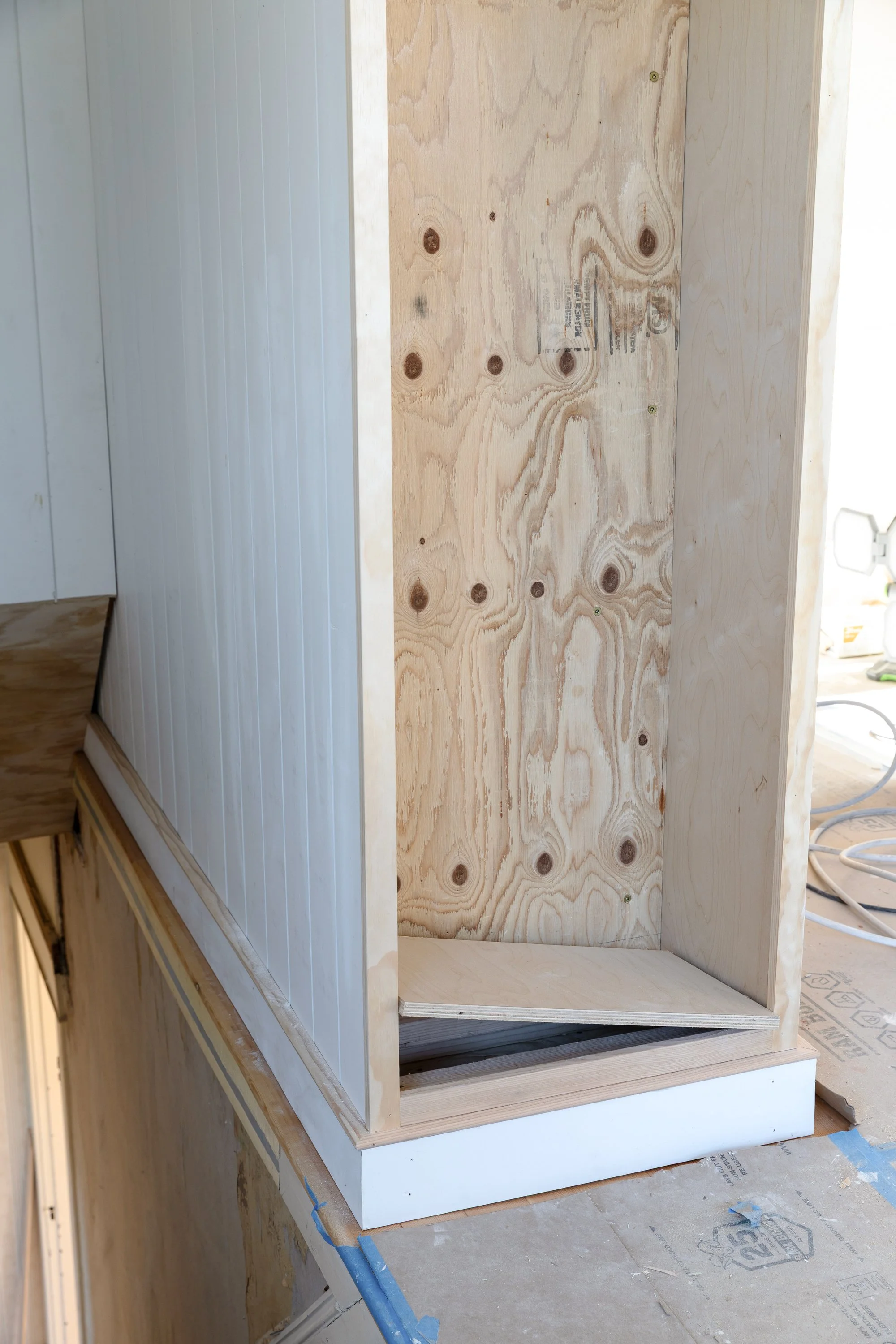 We're hiding a time capsule below a false bottom of a built-in bookcase at the Hill House renovation