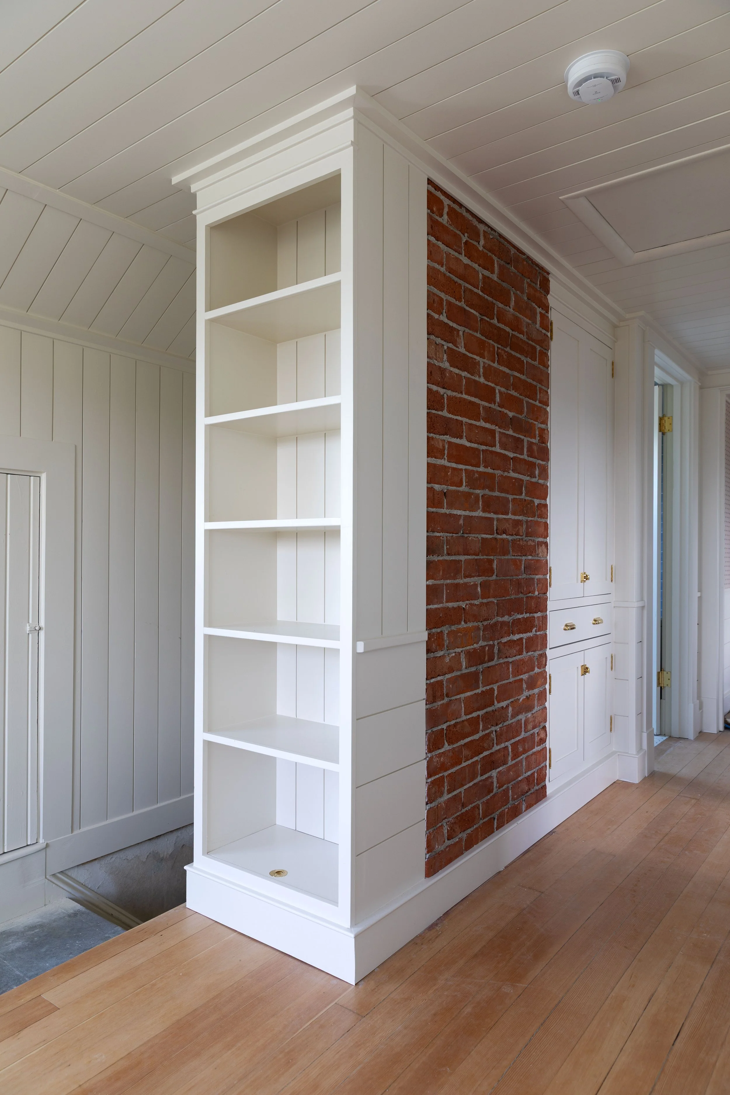 Small upstairs snug with built-in bookcase and storage in hallway