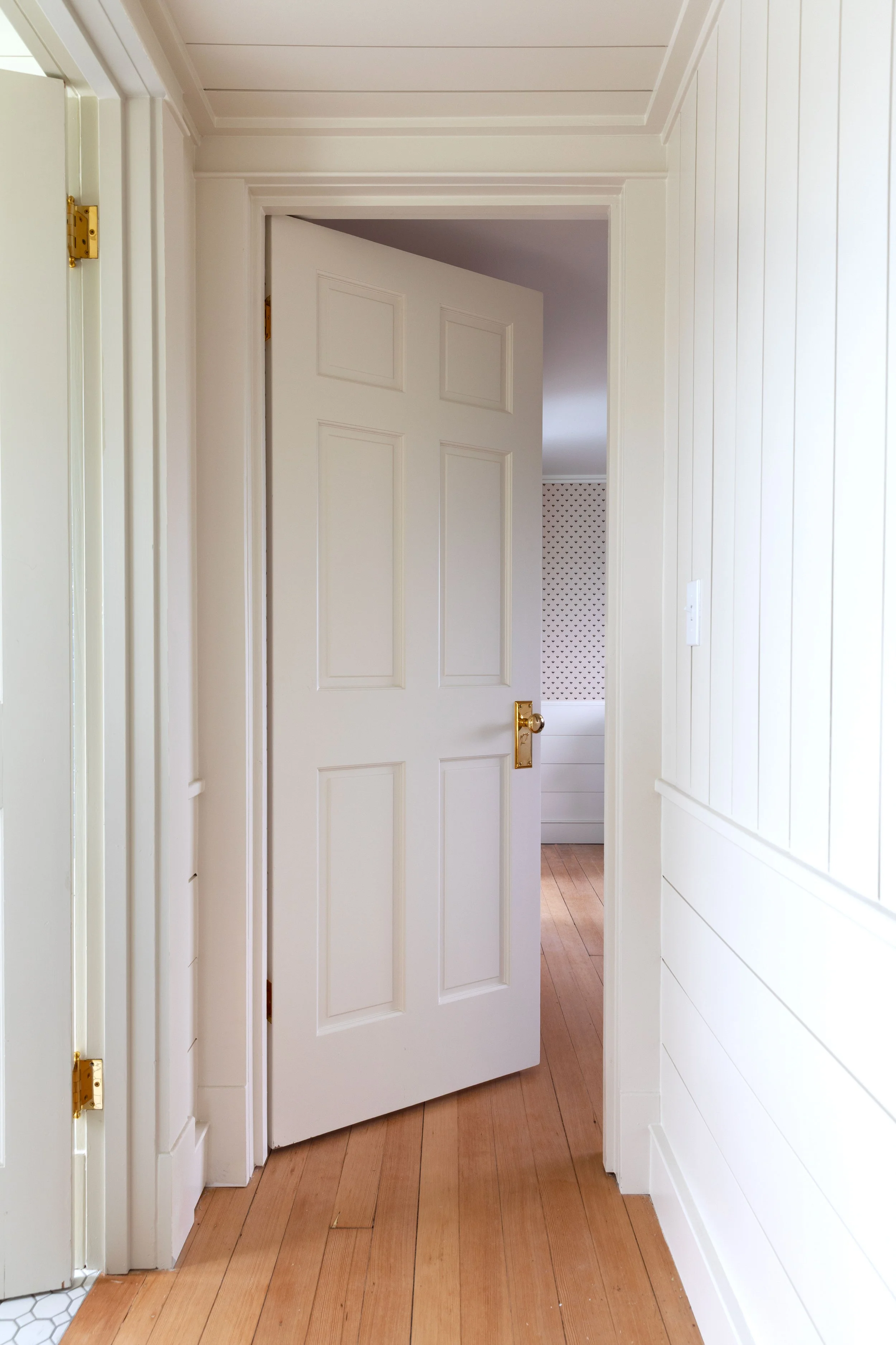 Vintage doors in the Hill House with brass hardware and panelled walls