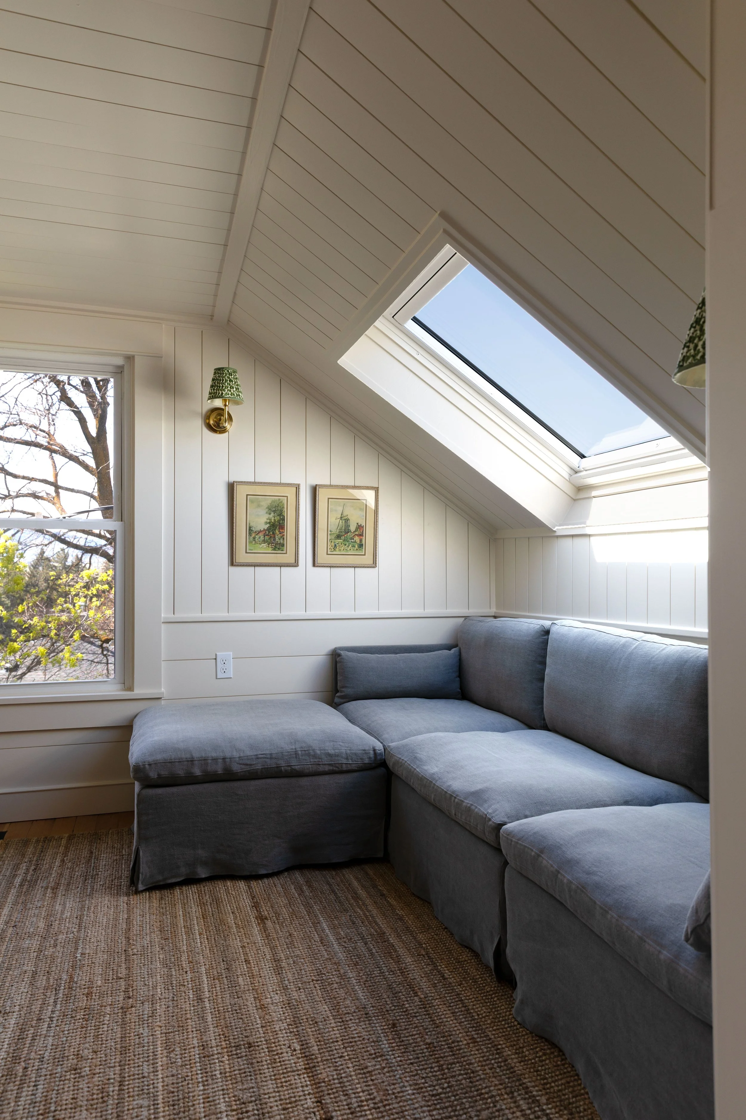 Finished upstairs snug design in the Hill House with low ceilings, sloped walls, and cozy seating