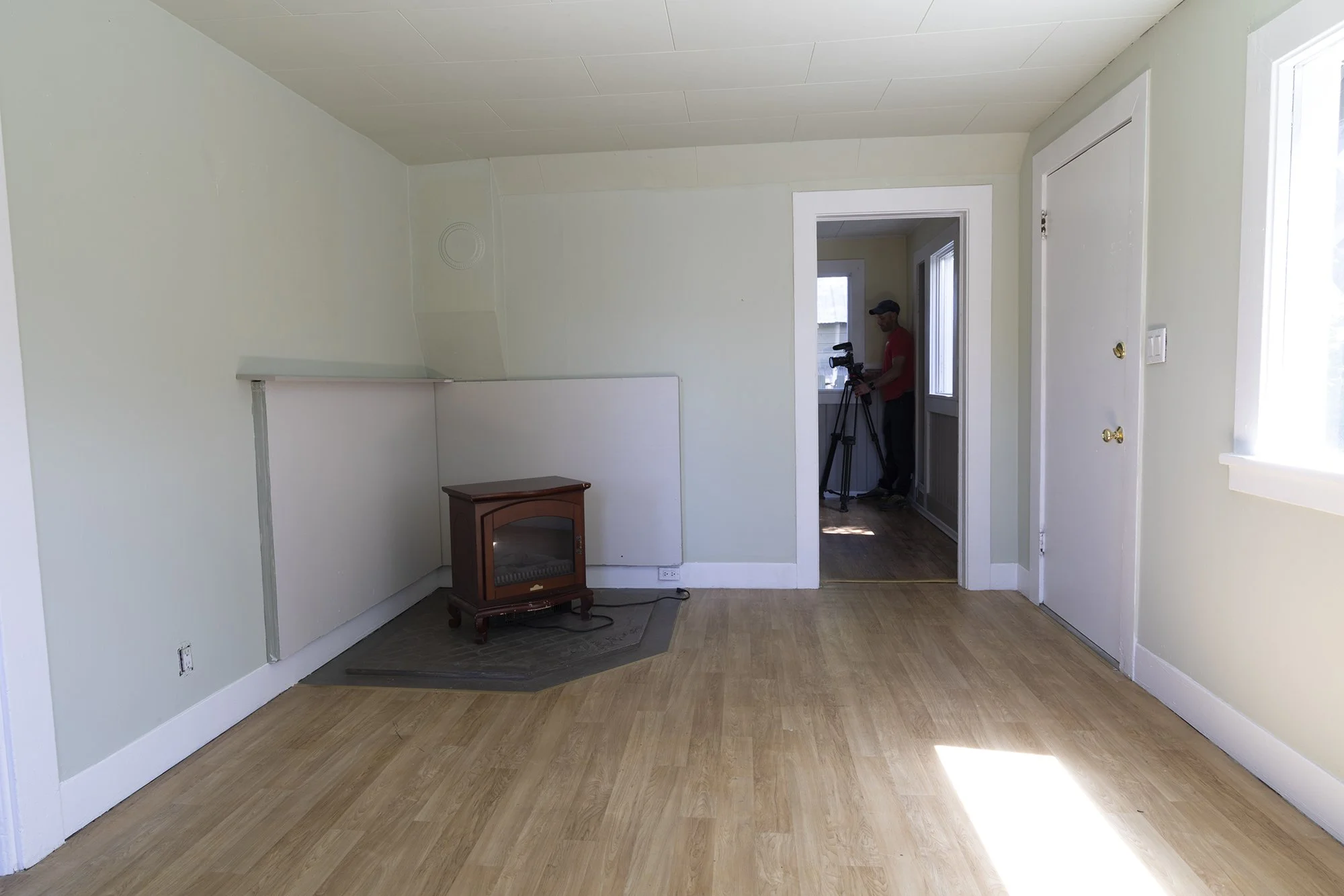 Before view from dining room to kitchen showing electric fireplace before stairs were added to the second story