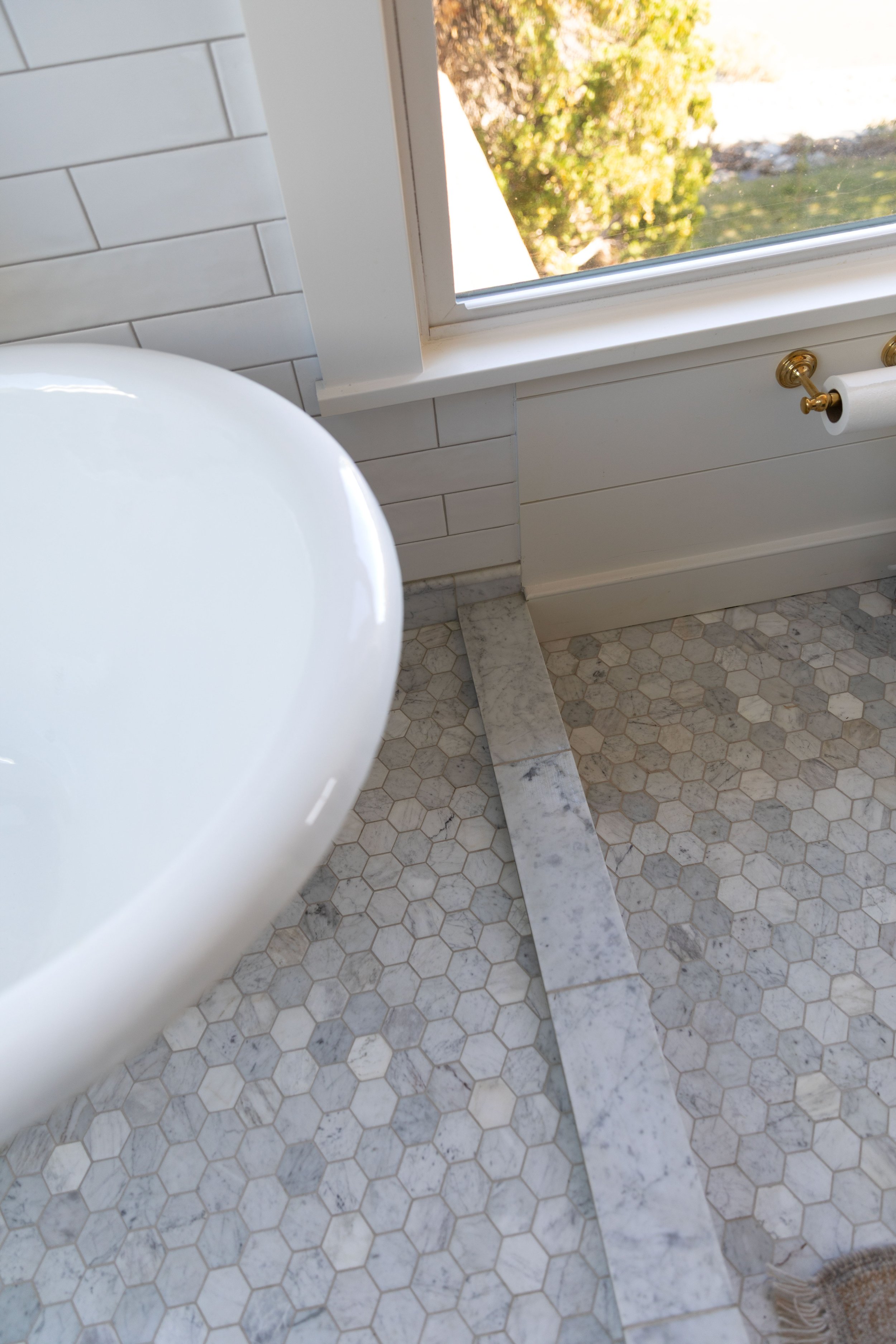 Marble hex bathroom floor with iron-colored epoxy grout in the Hill House ensuite