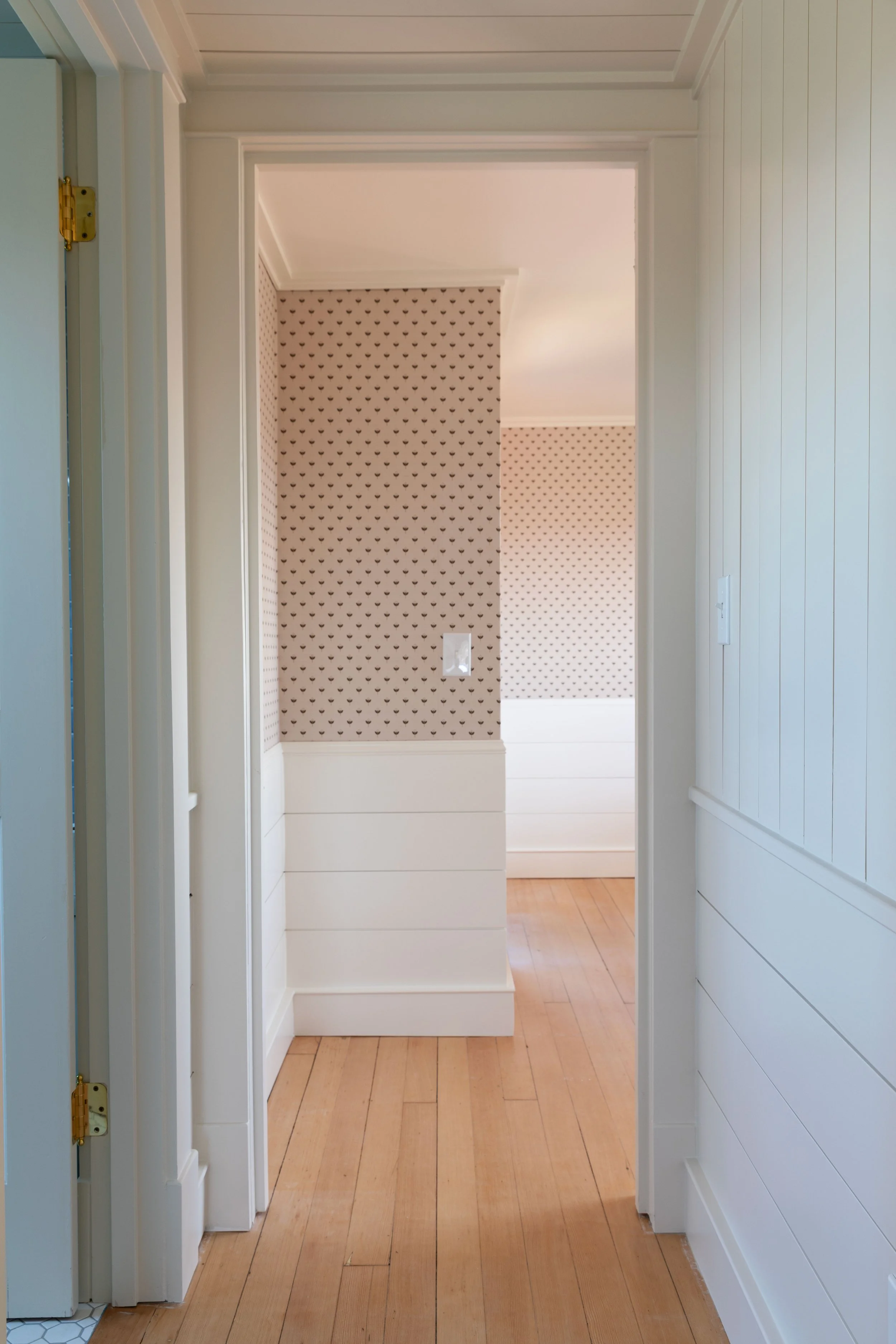 View into Daphne bedroom from hallway with Benjamin Moore Swiss Coffee on wainscot and ceiling