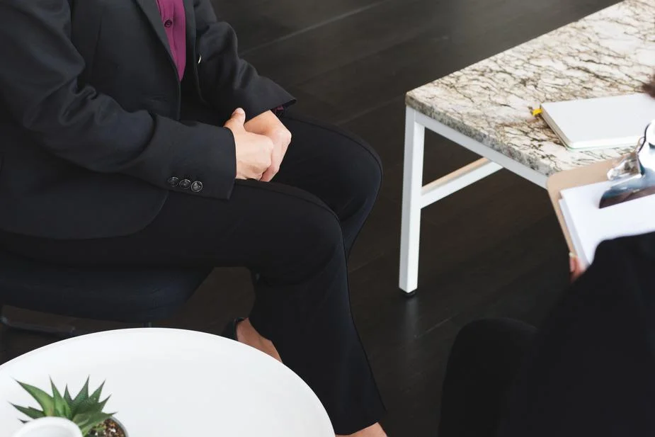 business-woman-sits-for-job-interview_925x.jpg