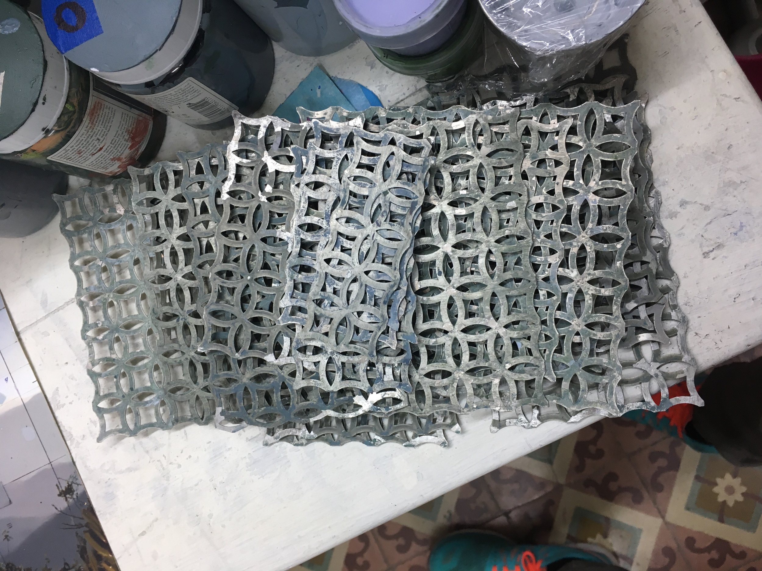 Fig 1.2 Perforated metal sheets used to produce the low-relief, elliptical patterns in the paintings. Photo by Tamir Williams