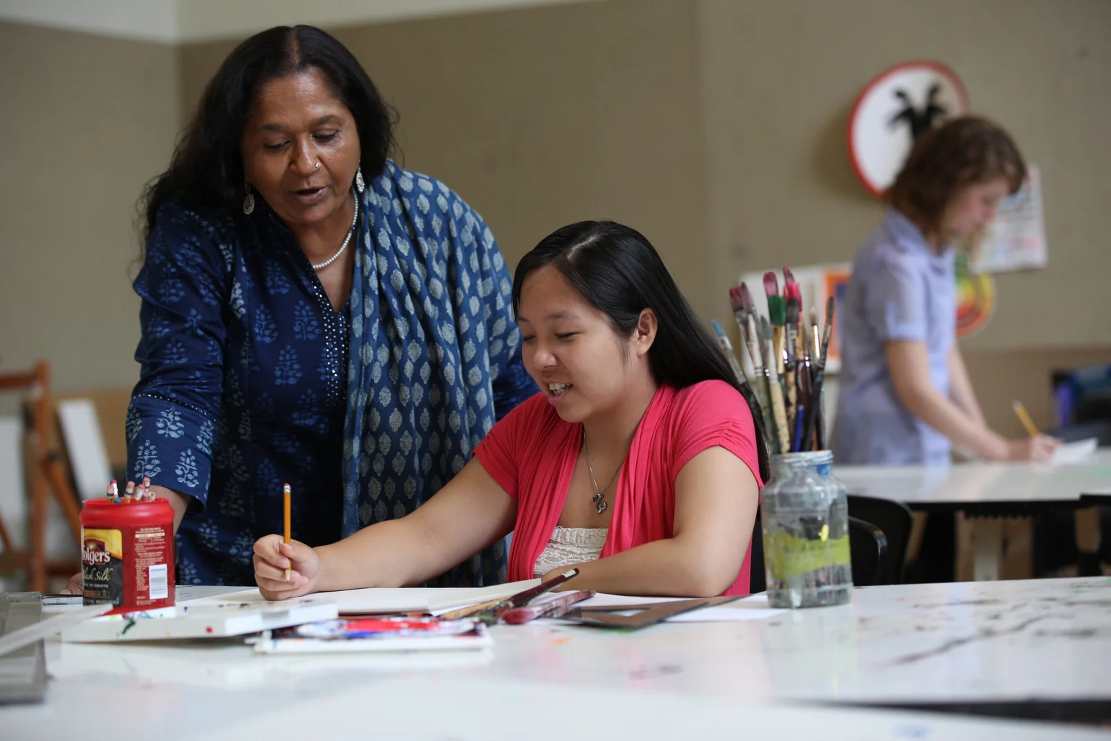 Dr. prajna parasher , professor and chair of arts, design and communication and program director of film and digital technology and interdisciplinary design, working with a student in the Art and Design Center.