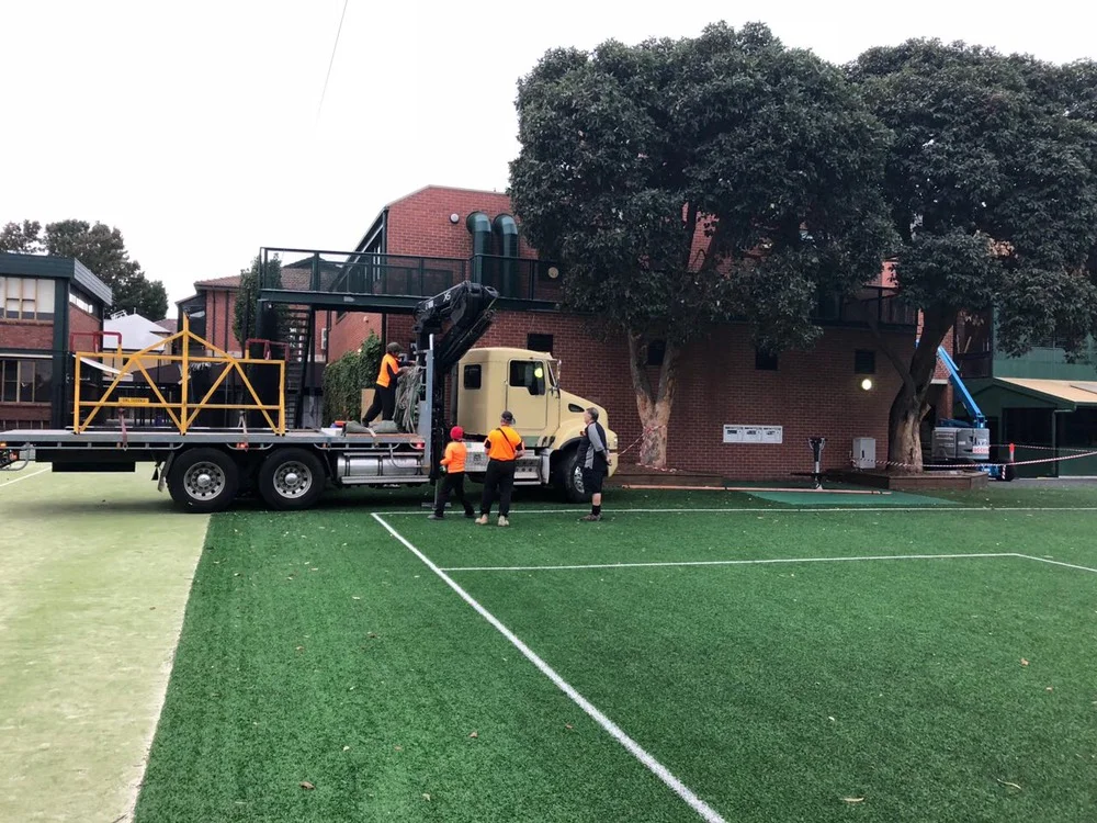 AC unit & crane vehicle setting up outside in a school ground