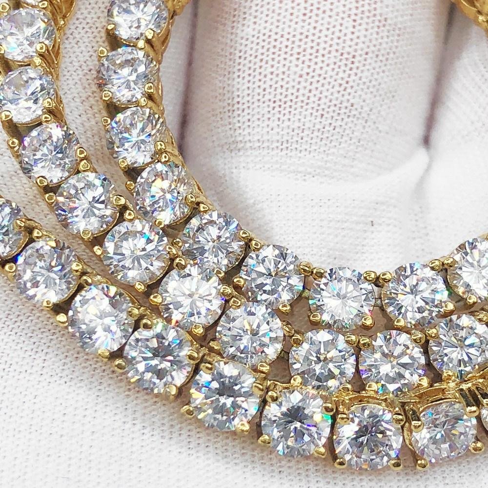 Gold jewelry with round diamonds on a white background