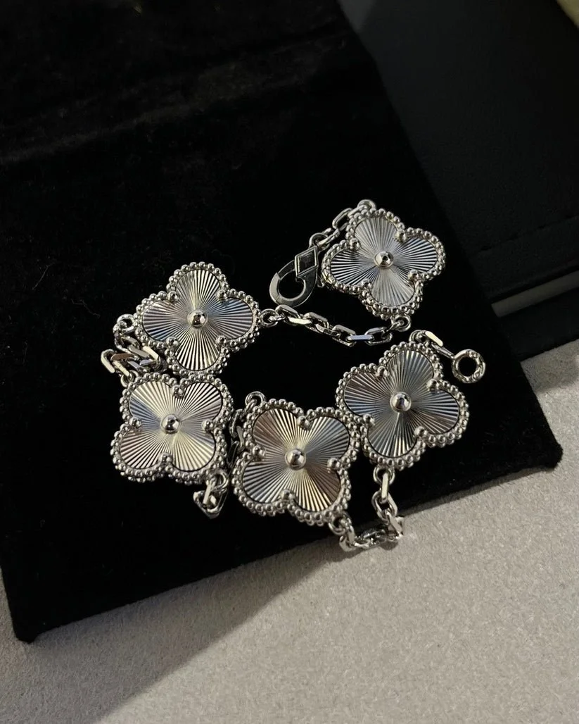 Close-up of a silver floral bracelet on a dark velvet background