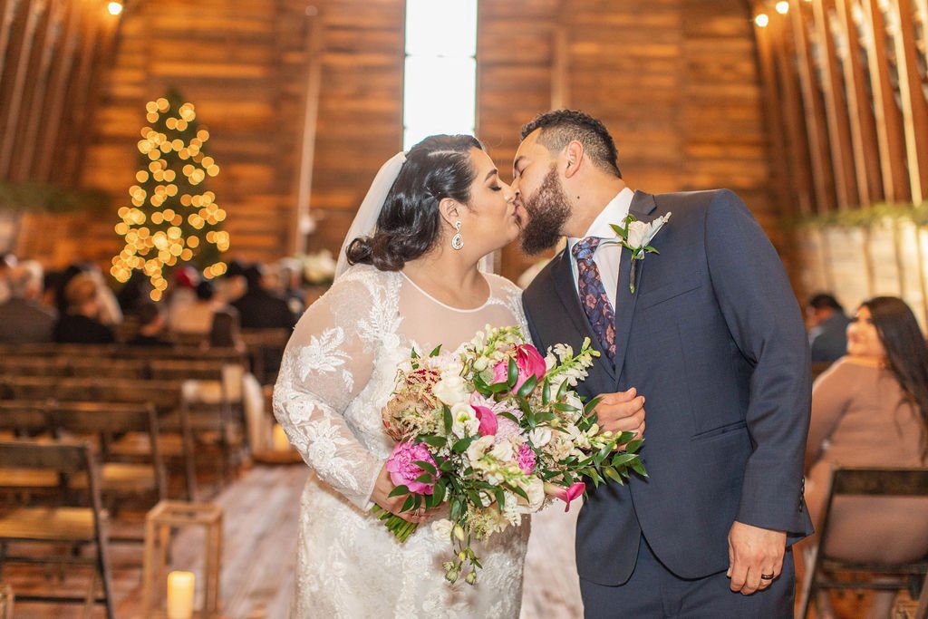  couple kissing inside barn wedding venue in eastern NC 